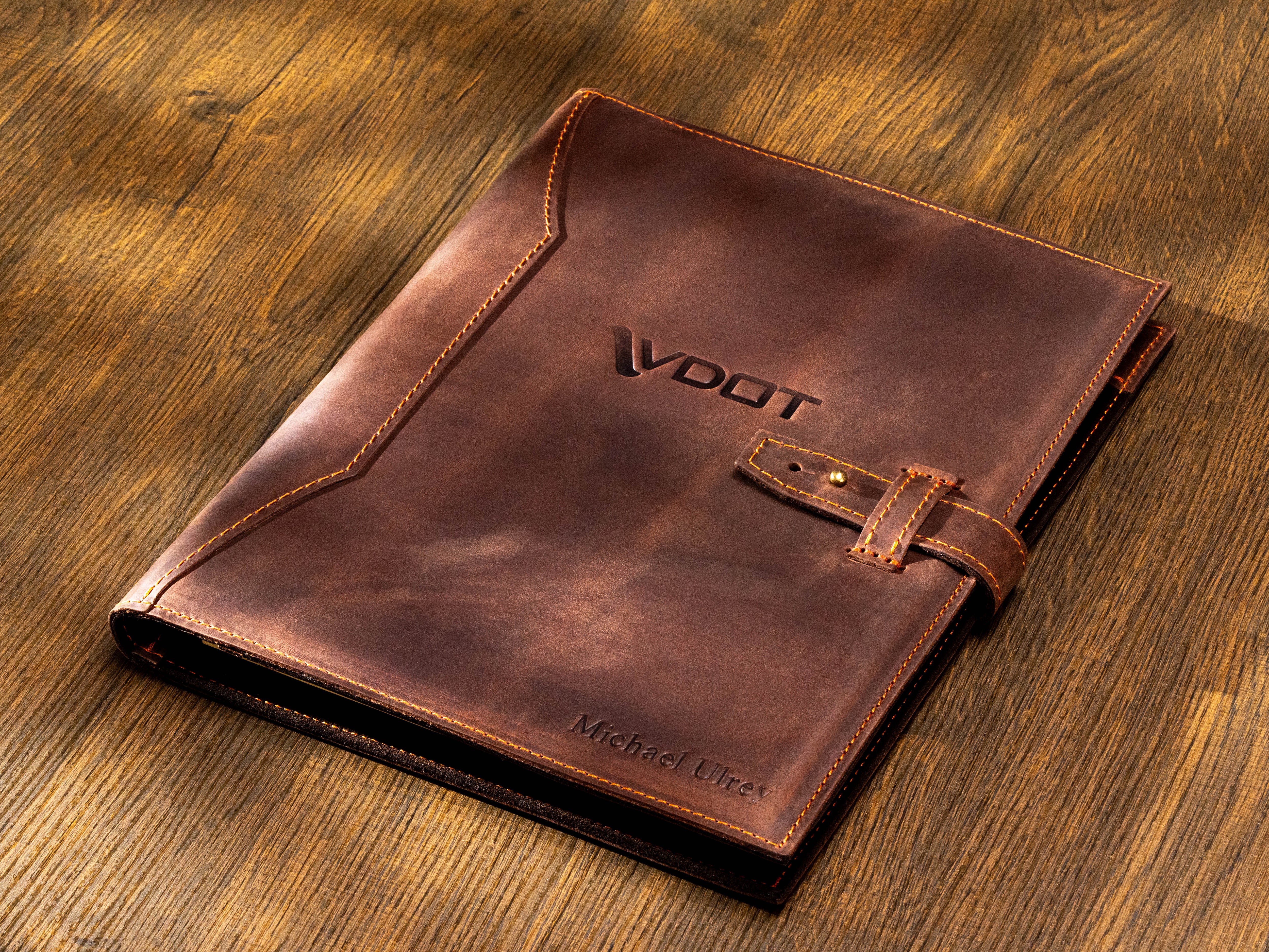 Personalized dark brown leather portfolio with custom company logo, name embossing and strap closure