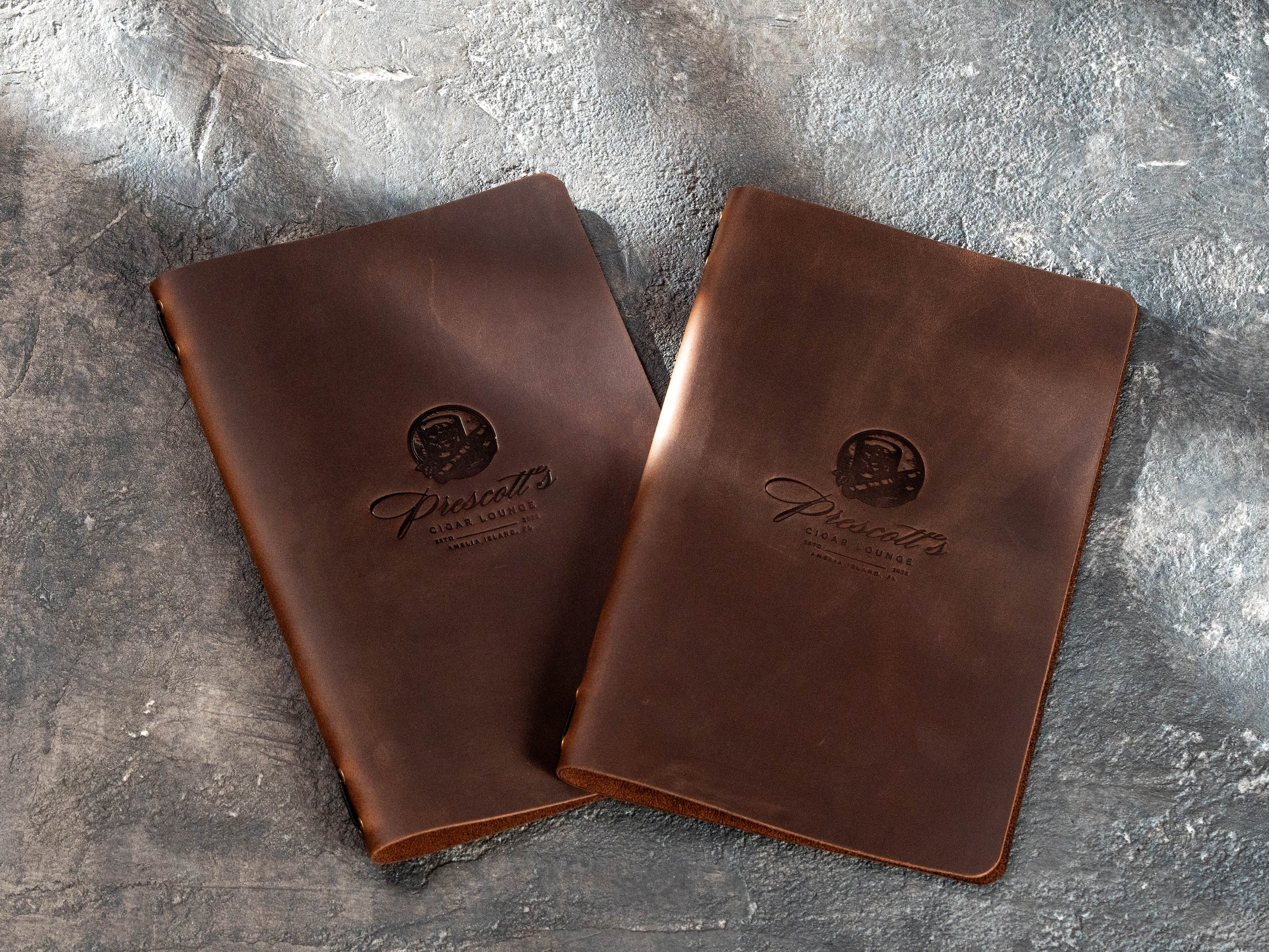 personalized brown leather menu covers with embossed Prescott’s Cigar Lounge logos