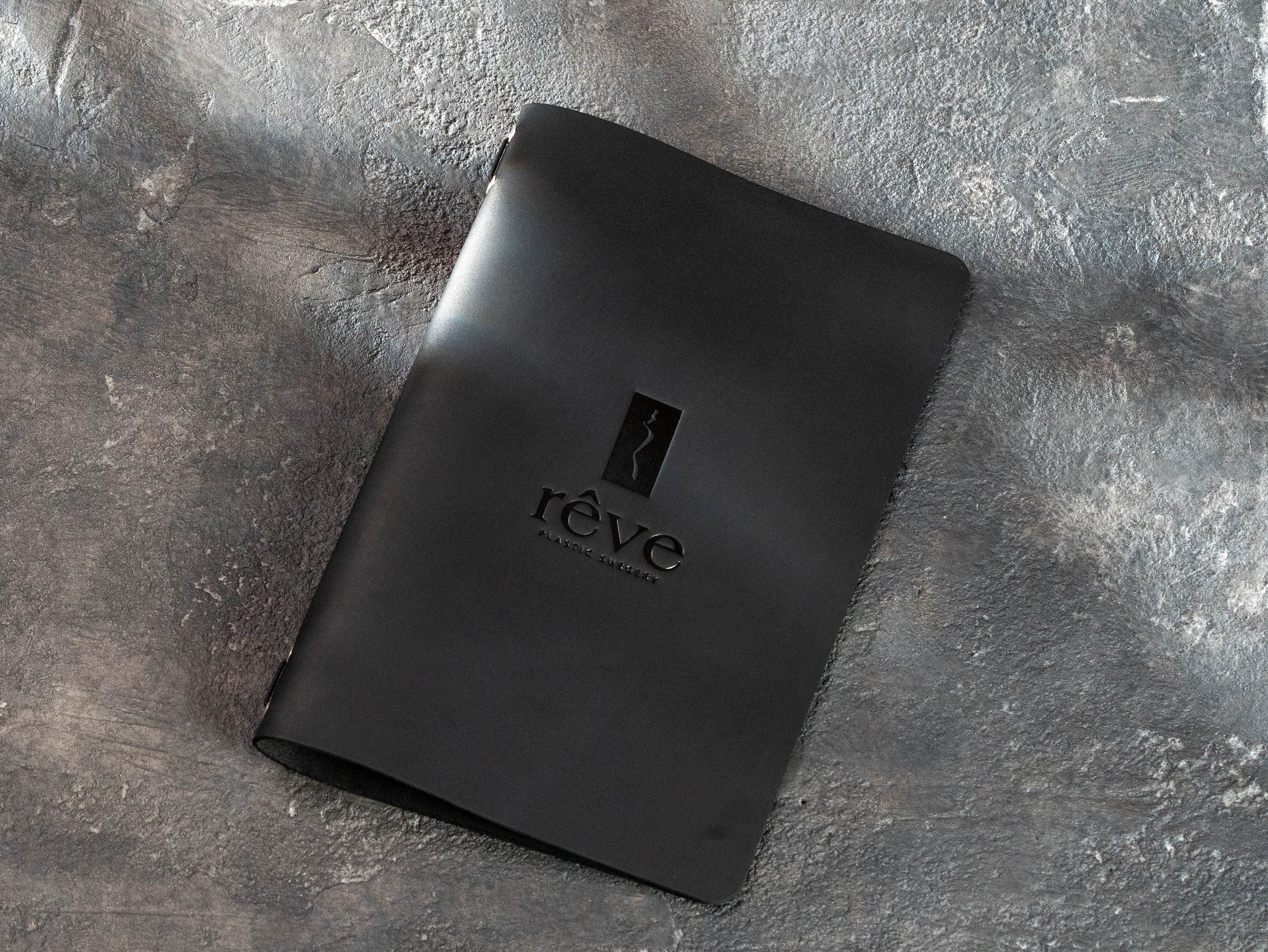 black leather menu cover sample with custom Rêve Bistro & Bar logo