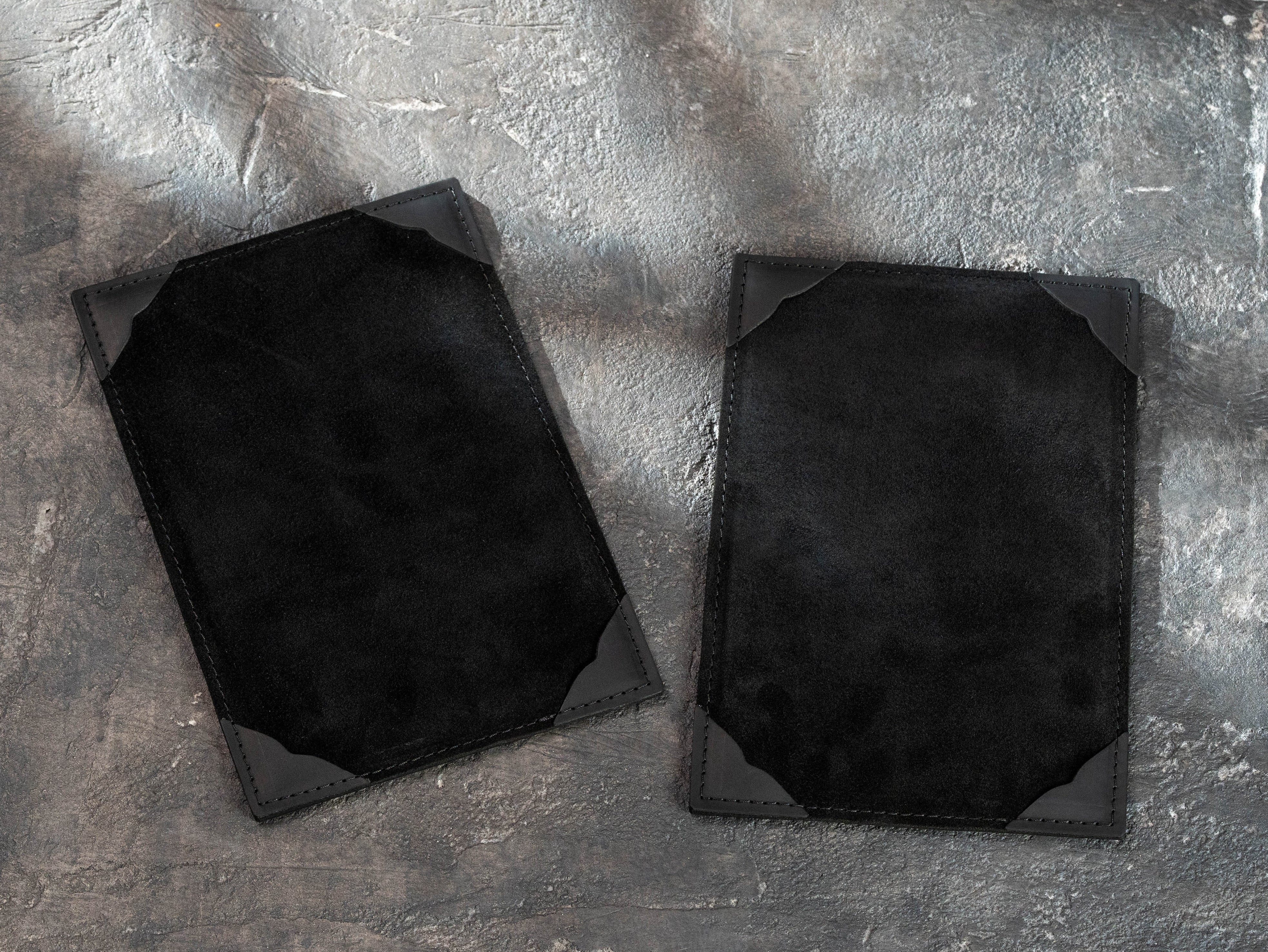 black leather A5 menu boards showing suede surfaces and leather corner holders for printed menu pages