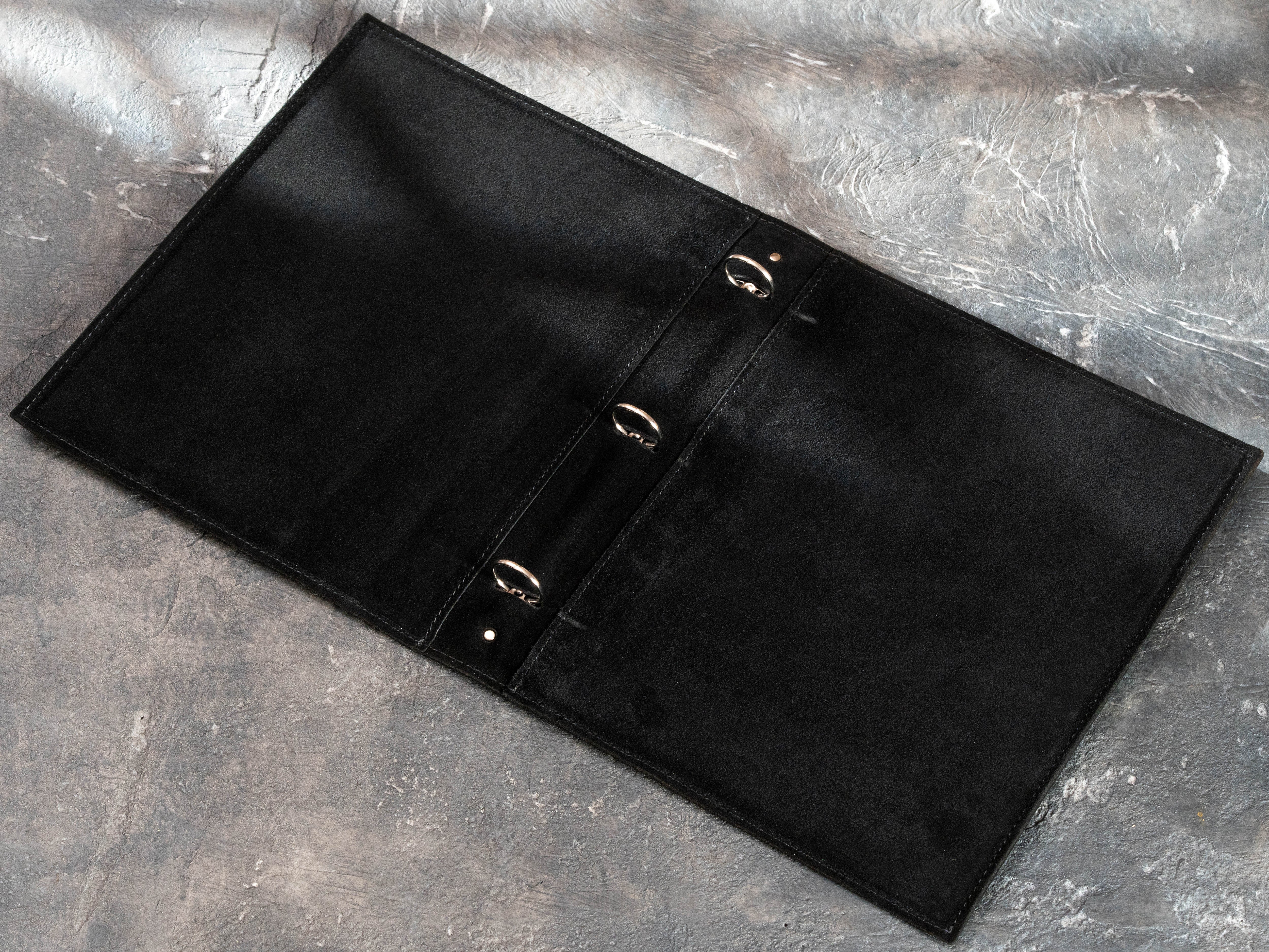 Open black leather 3-ring binder with soft suede interior and metal 25 mm ring mechanism
