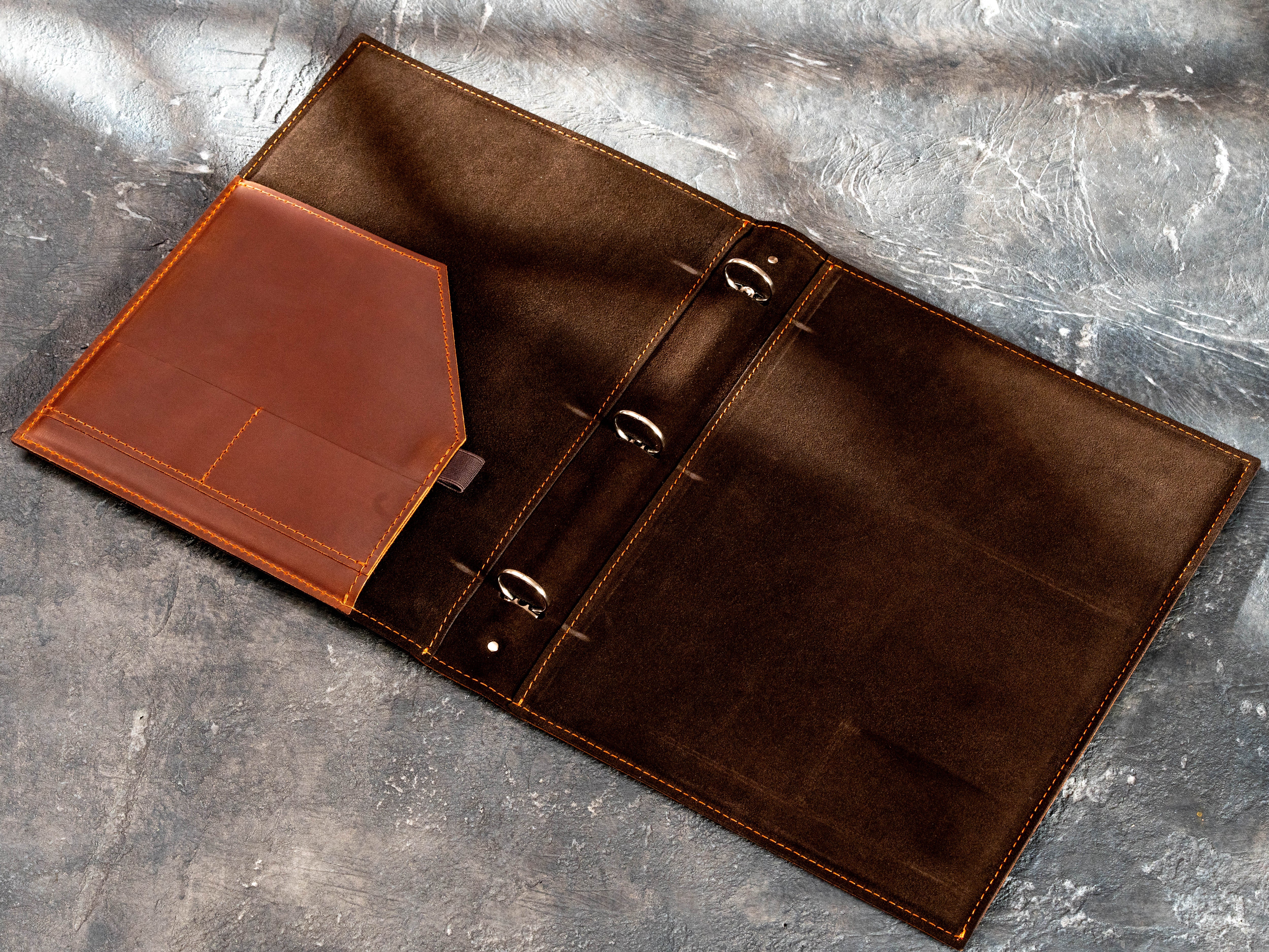 Open personalized leather business binder showing the large shaped pocket and empty 3-ring mechanism