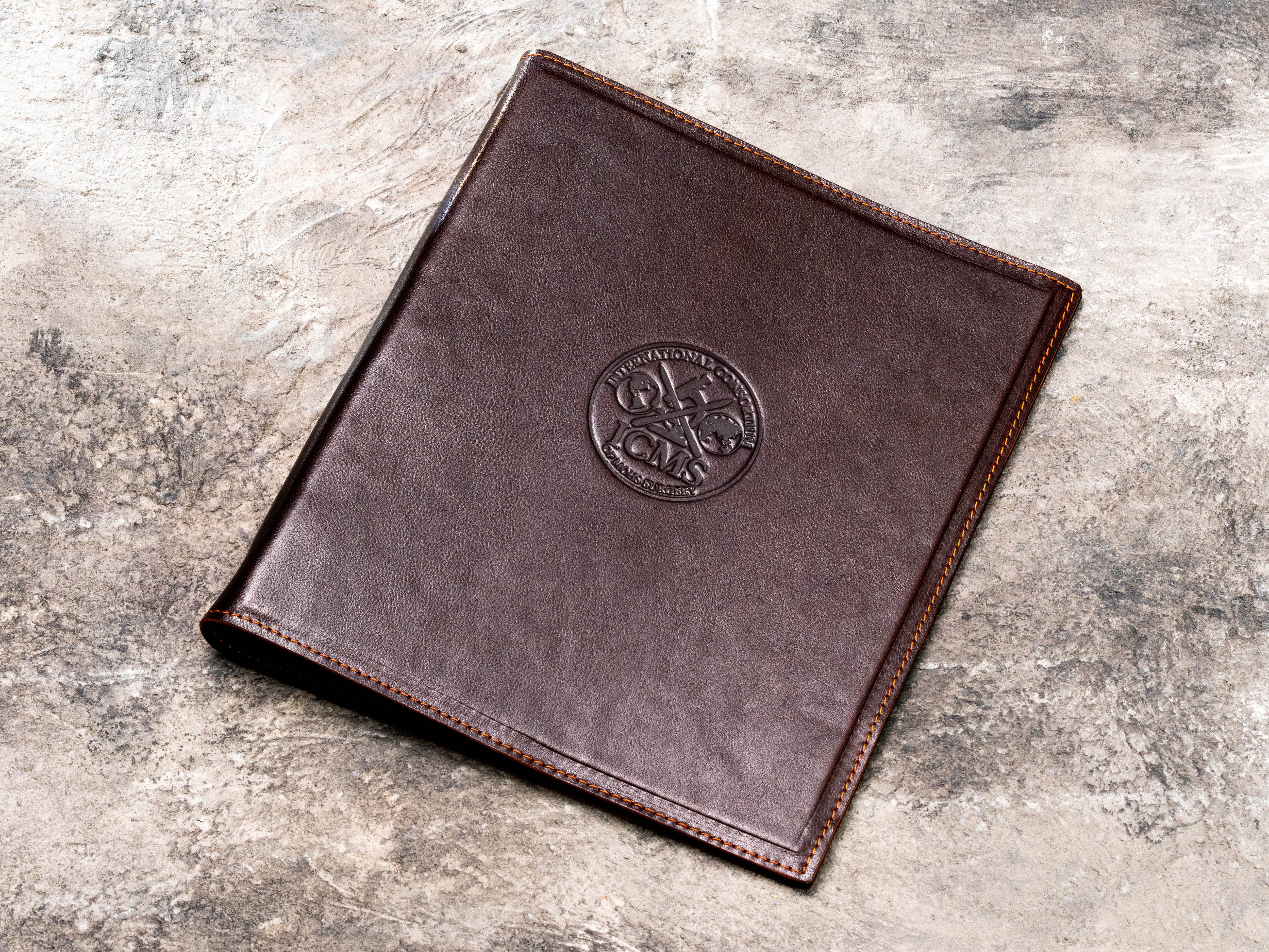 Personalized dark brown leather construction project binder with custom embossed professional logo