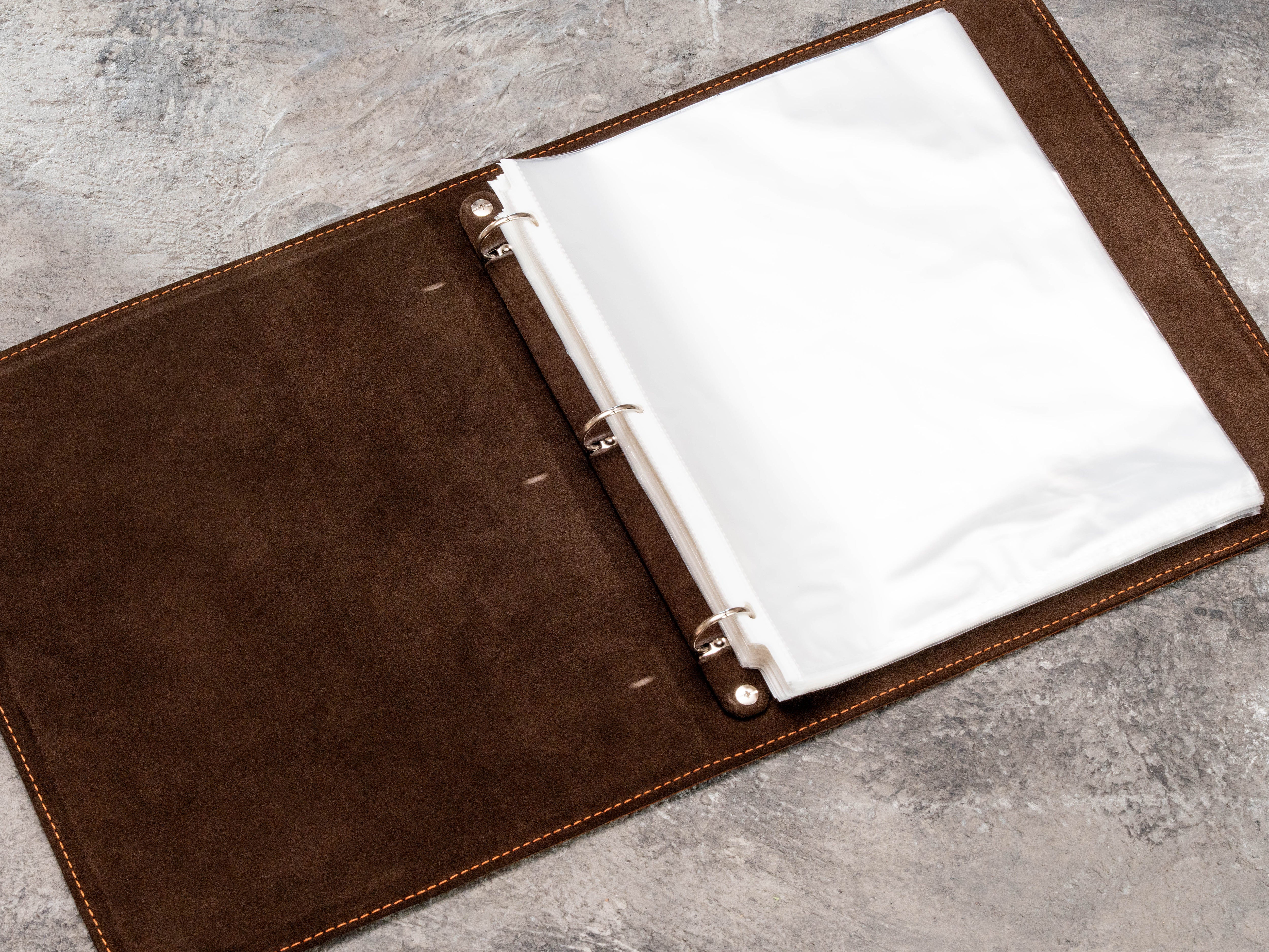 Open dark brown leather binder with 25 mm 3-ring mechanism and 8.5 x 11 page protectors
