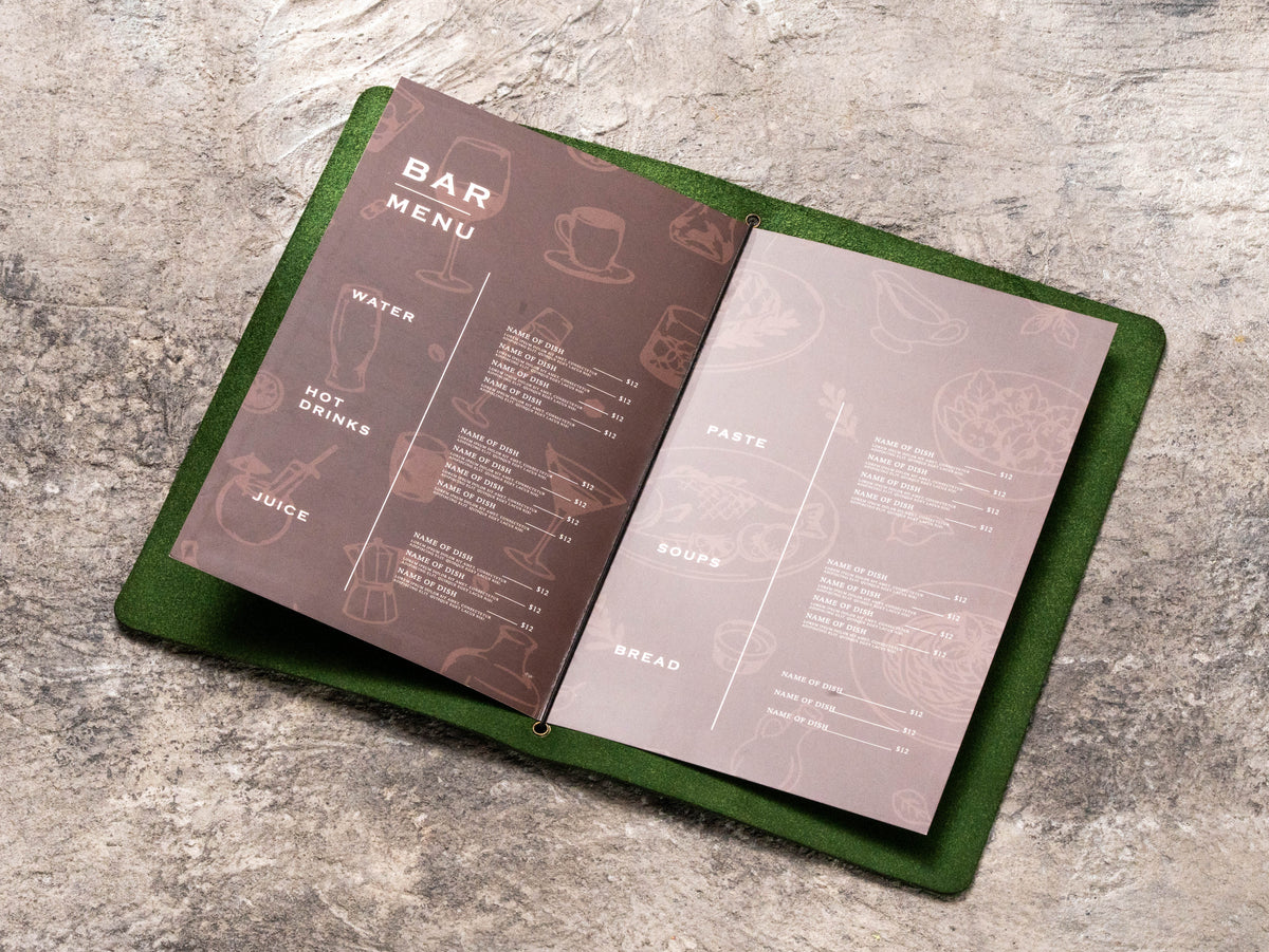 Dark green leather restaurant menu folder with printed menu pages secured by center elastic cord
