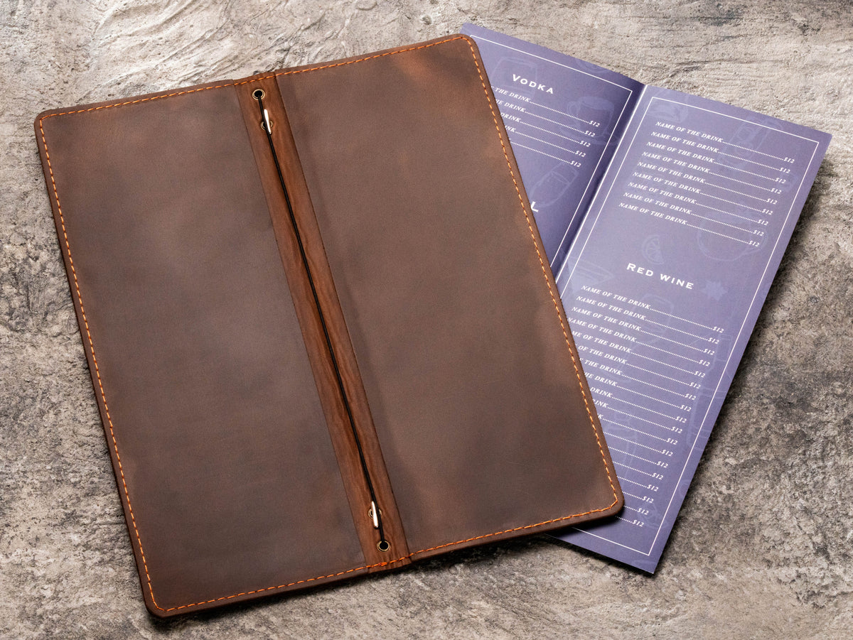 Open brown leather wedding menu folder with center elastic cord for replaceable menu pages