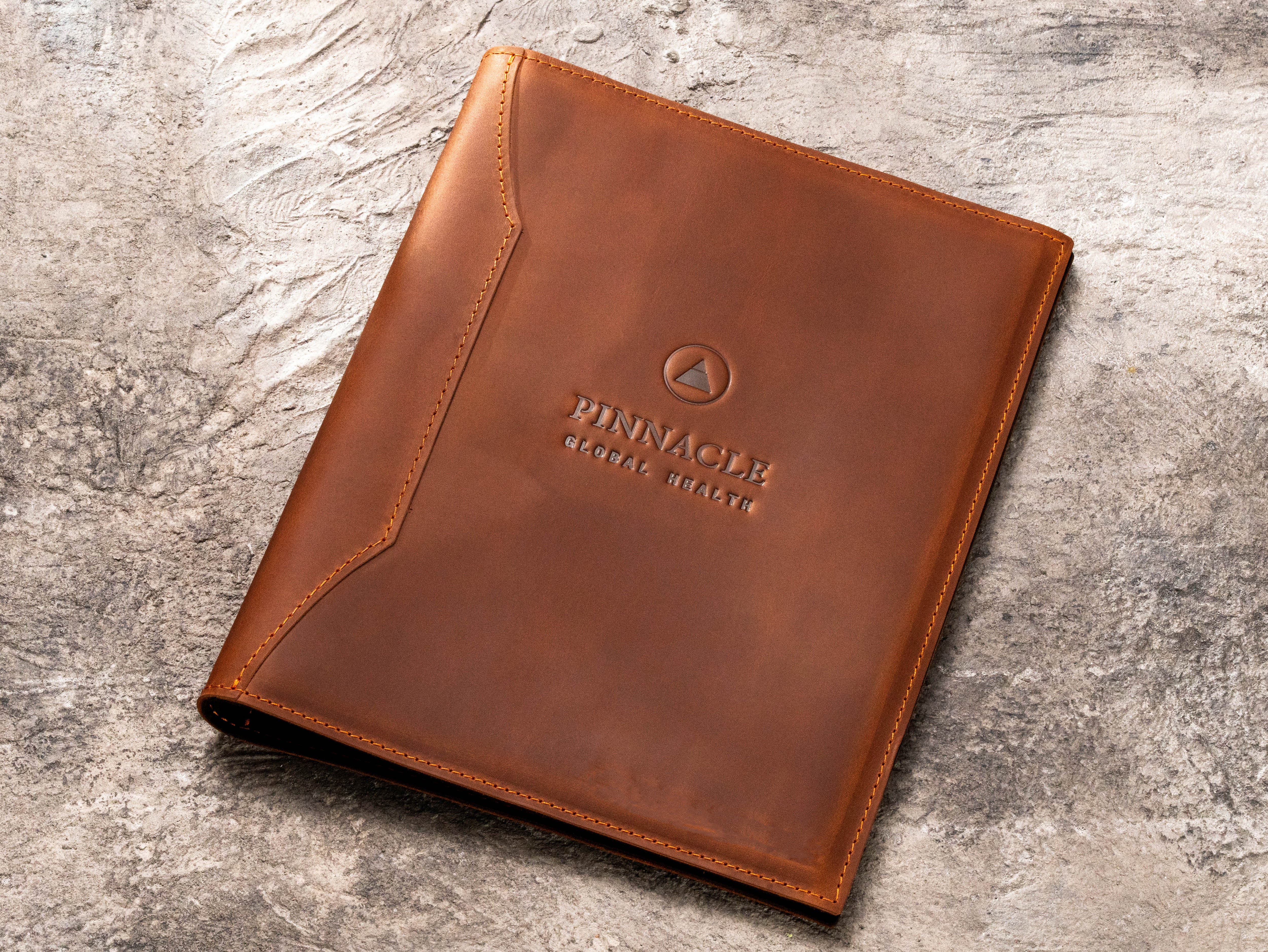 Custom brown leather healthcare document binder with blind embossed company logo