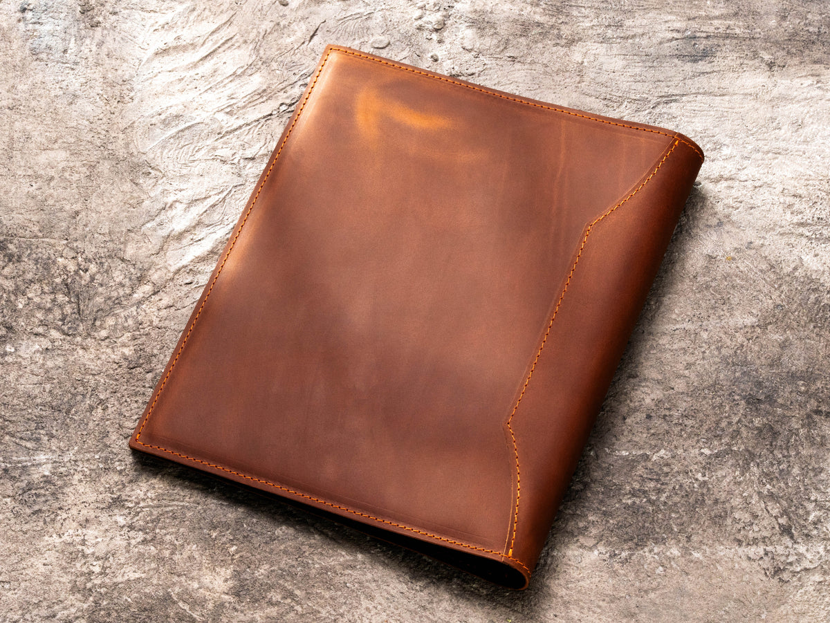 Back view of brown leather corporate medical document binder with stitched edges