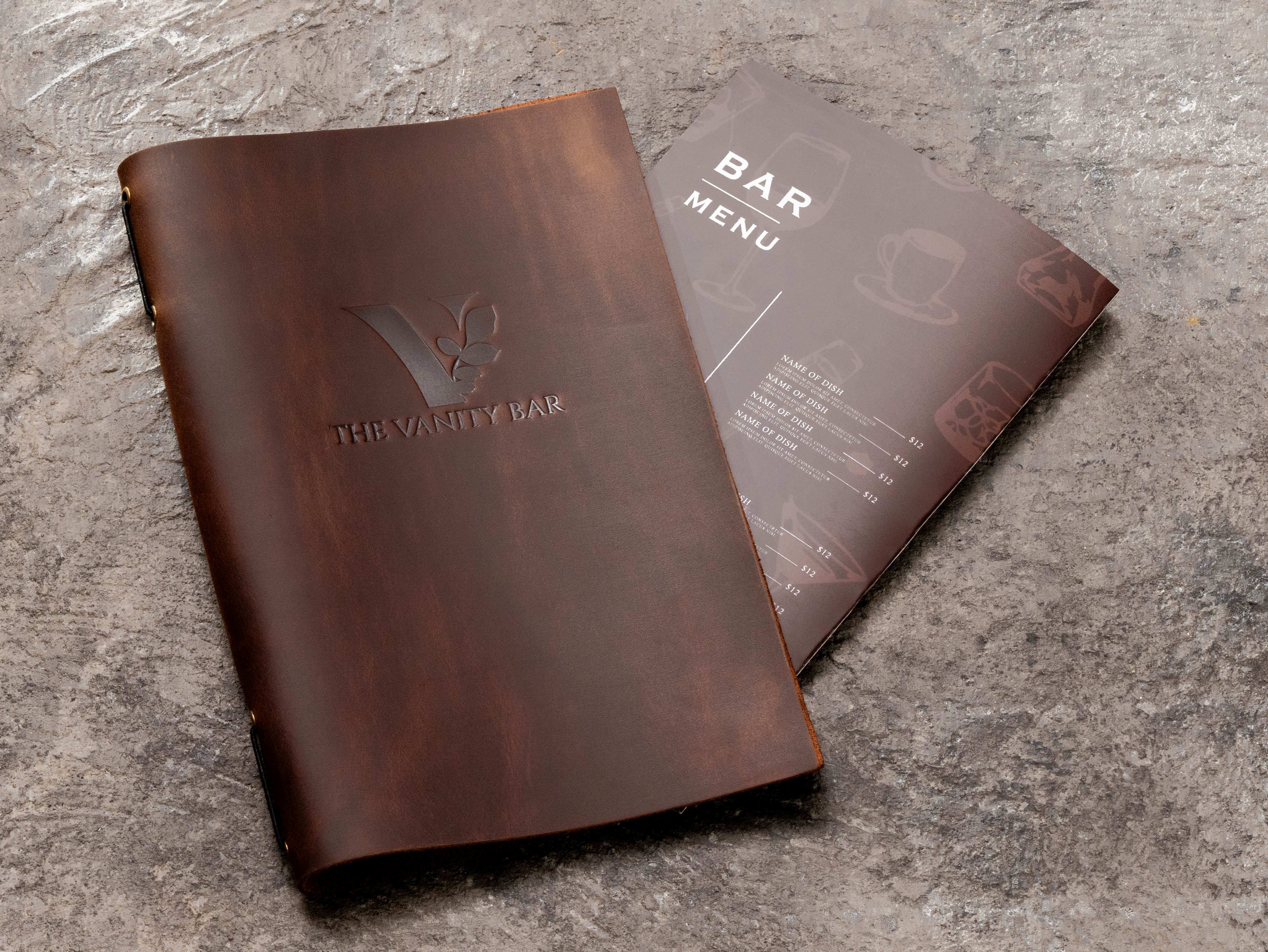 Brown leather med spa service menu cover with custom blind embossed logo and 8.5 x 11 menu insert