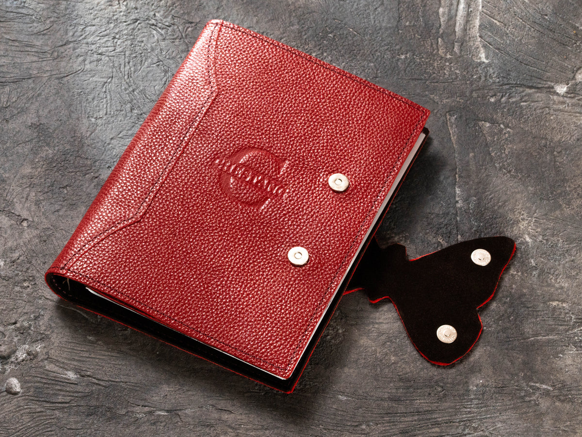 Red corporate leather planner with removable butterfly magnetic clasp and tone-on-tone logo embossing