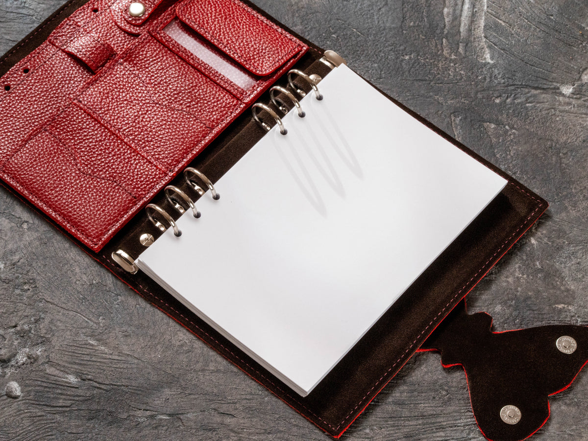 Refillable 6-ring corporate leather planner with blank A5 pages and removable business organizer