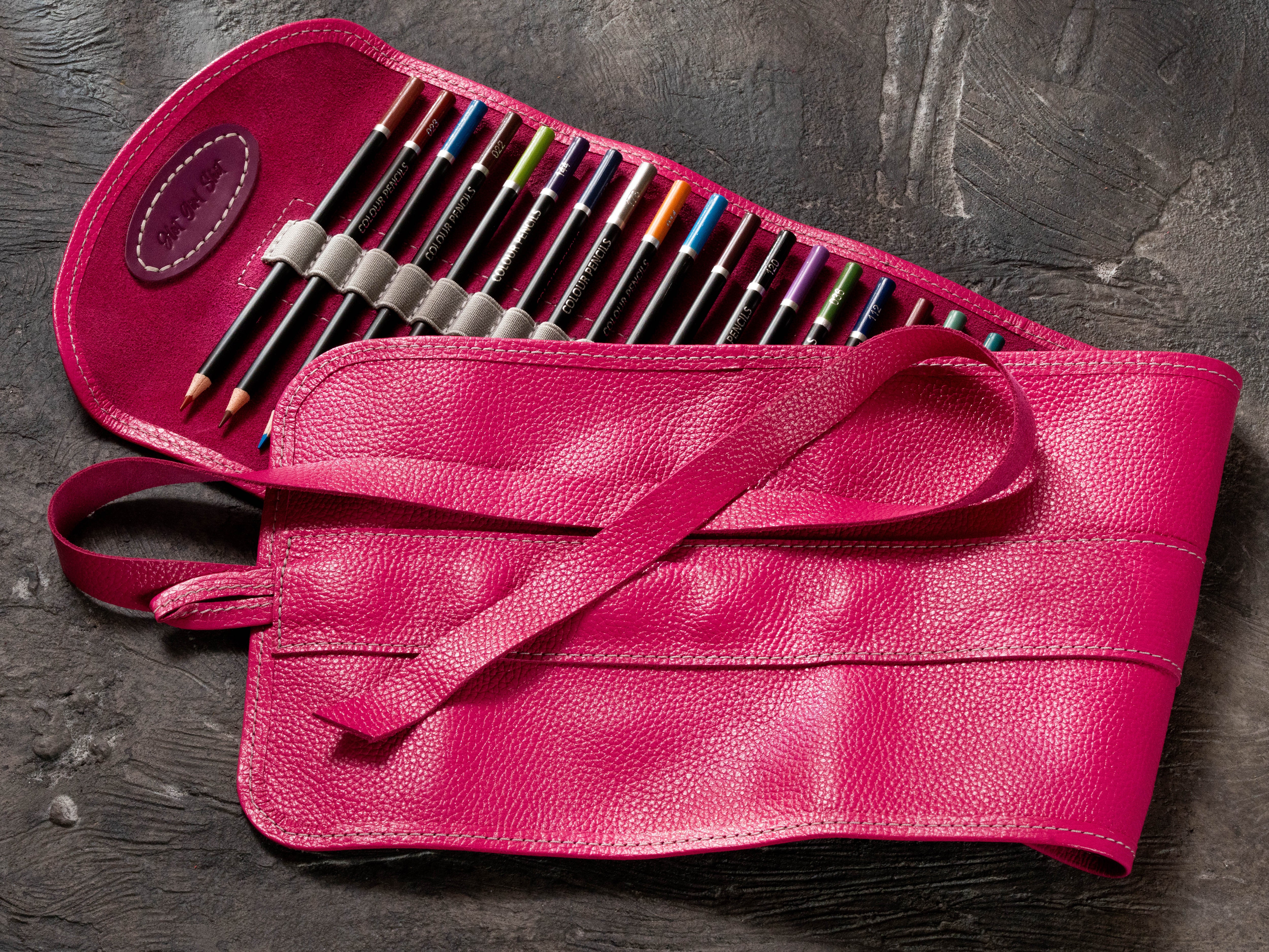 Personalized pink leather artist pencil roll filled with colored pencils and tie closure