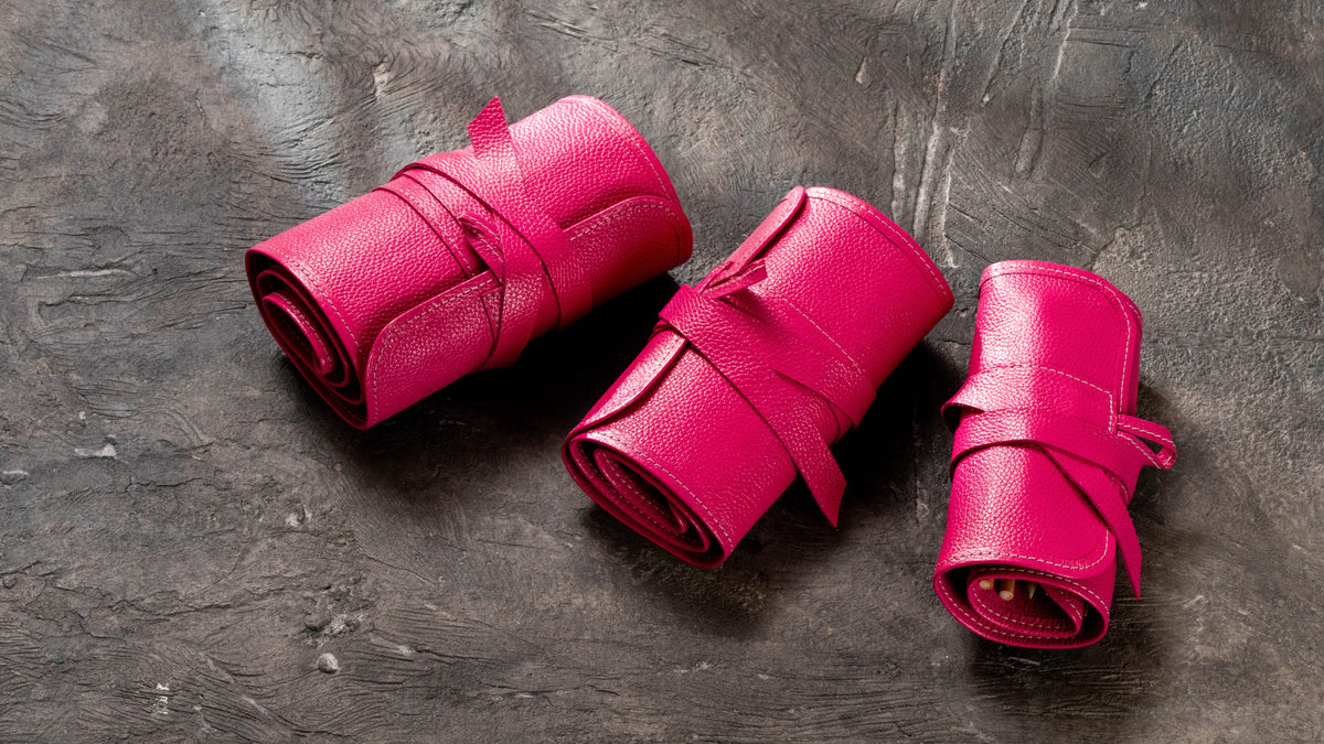 Small Medium and Large bright pink leather pencil rolls rolled and secured with leather ties