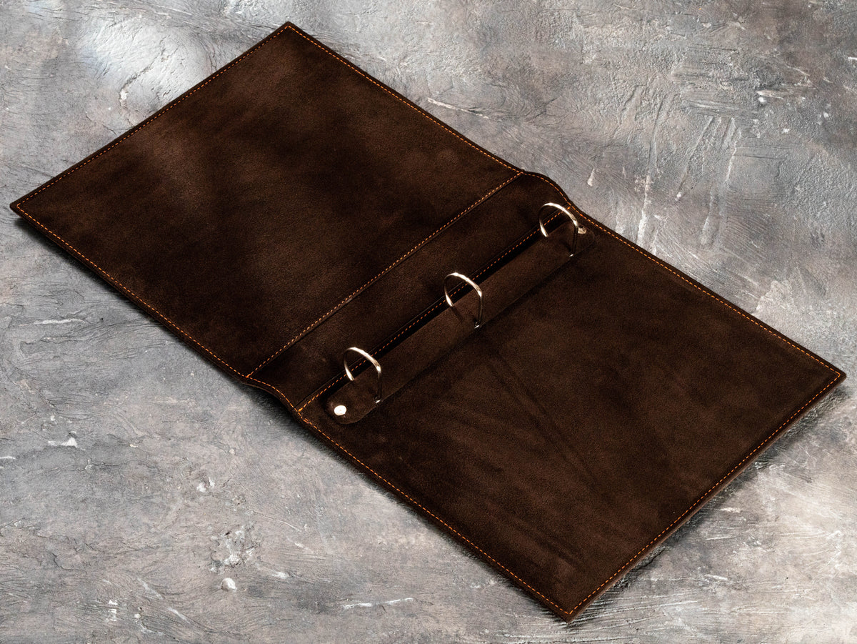Open brown leather 3-ring D-binder with dark suede interior for 8.5 x 11 business documents