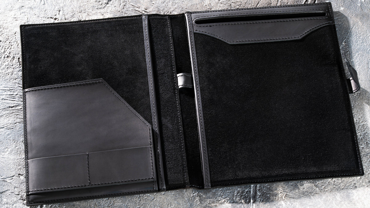 Open Black leather padfolio with black suede interior, document pockets, card slots and pen loop