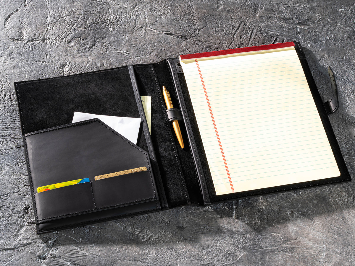 Black leather portfolio with legal pad, pen, documents and business card pockets