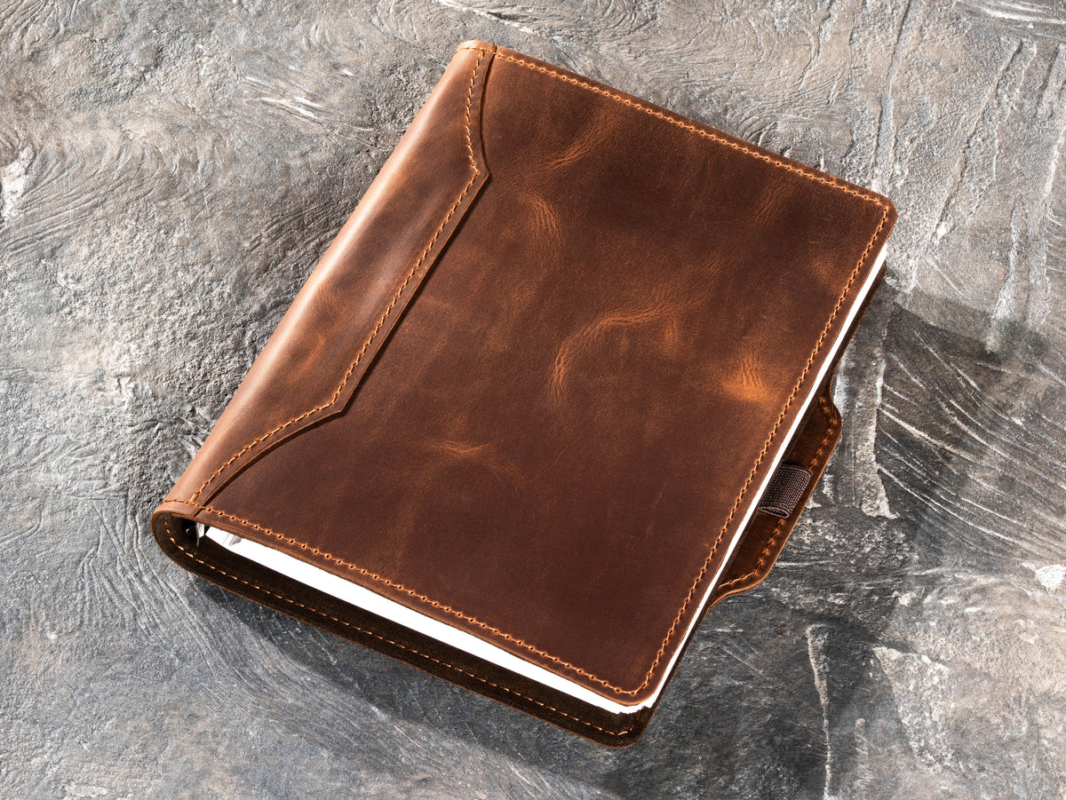 Milk Chocolate leather business notebook viewed at an angle with refillable pages inside