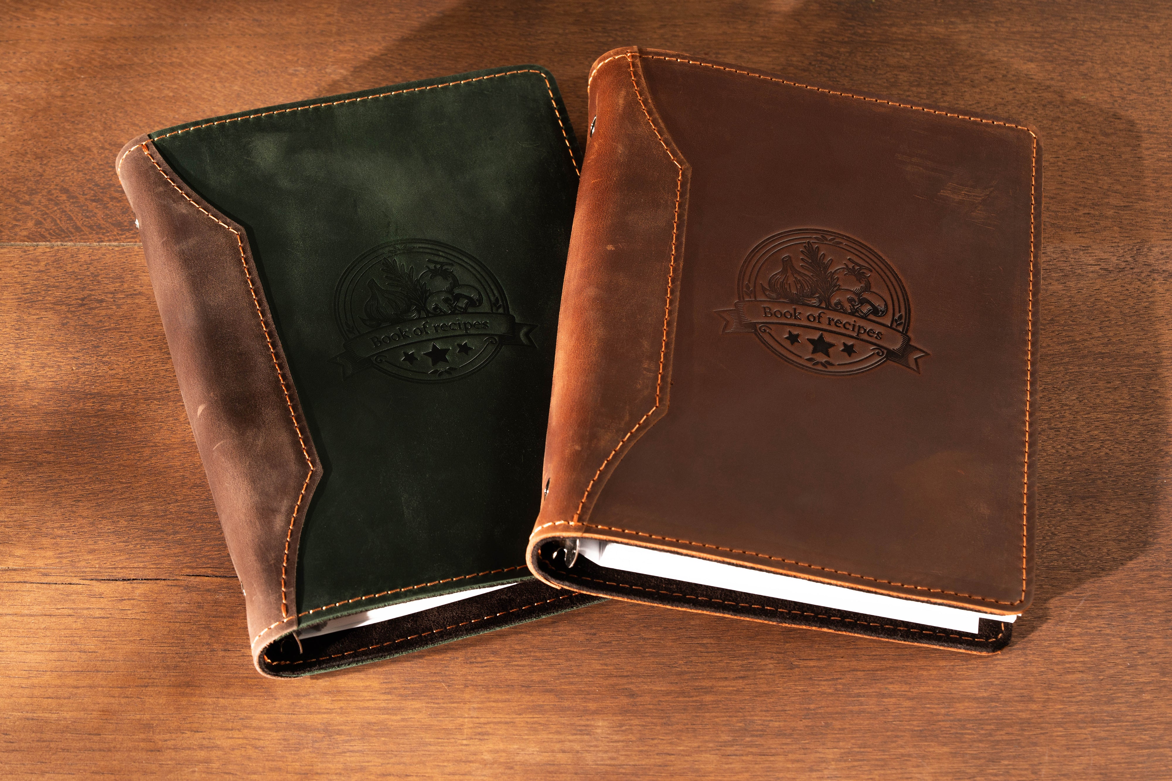 Two leather-bound notebooks with embossed logos