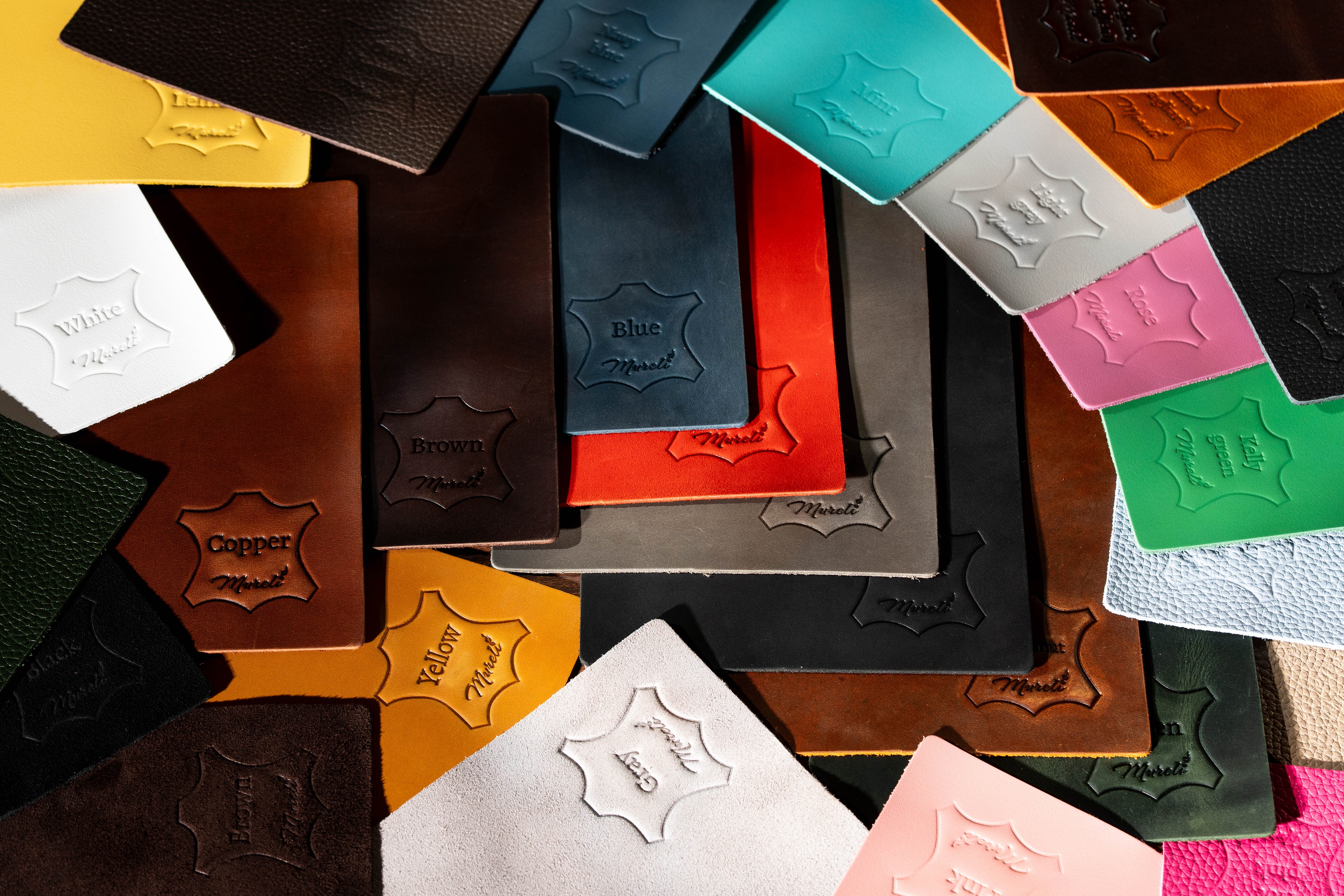 Collection of Mureli leather color swatches with stamped names and logos for custom and wholesale orders