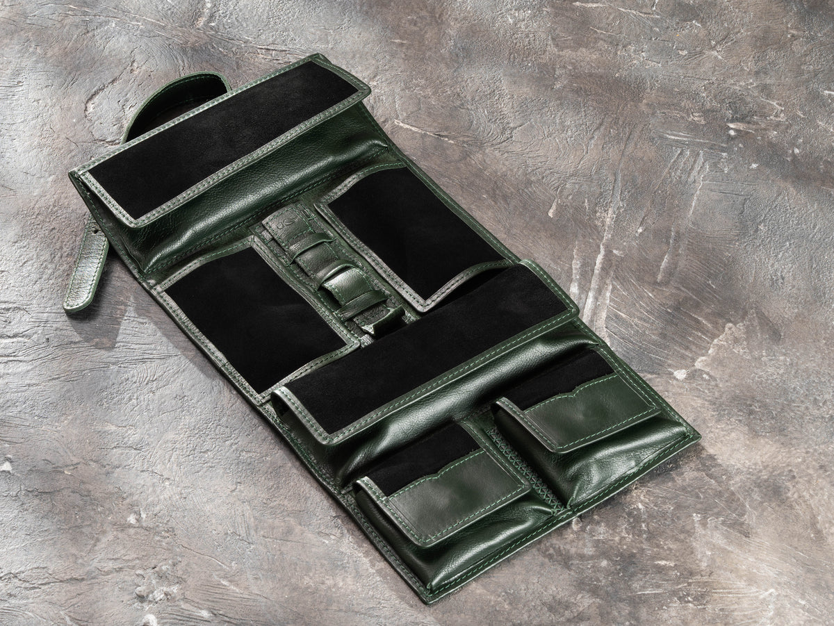Open Dark Green leather travel organizer showing magnetic pockets, suede interior and elastic holders