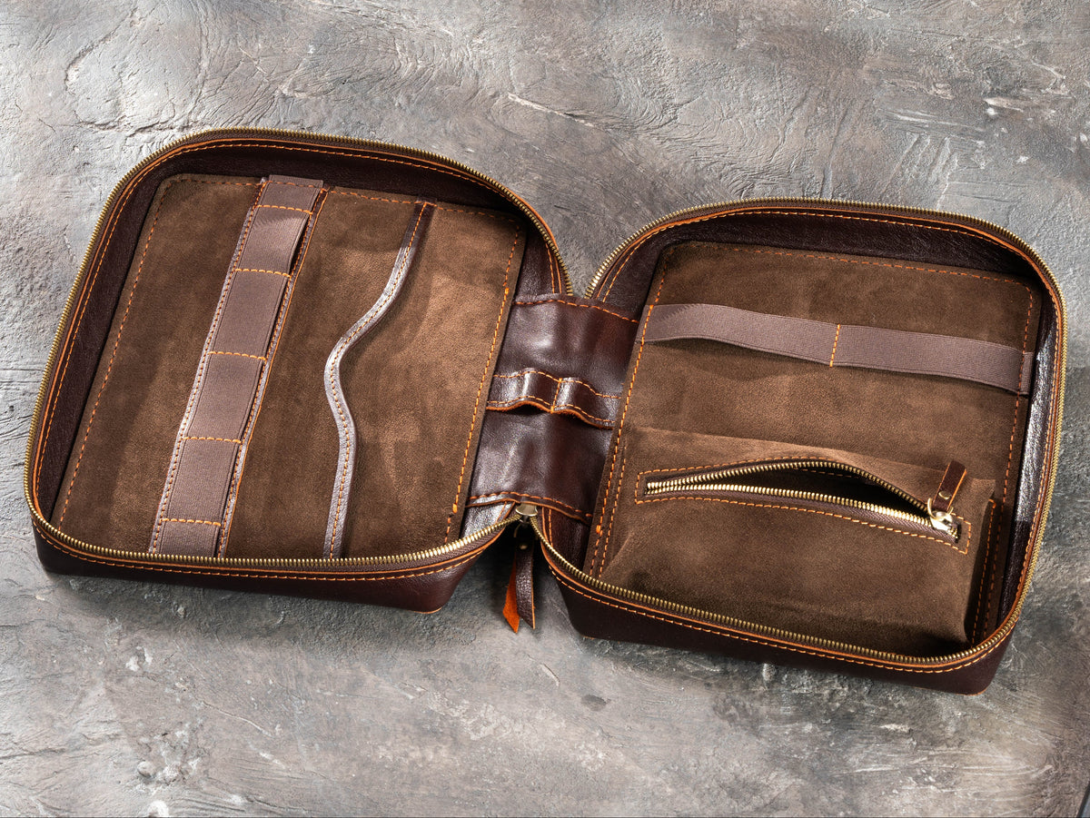 Open Dark Cognac zippered leather travel case showing suede interior, flat pocket, elastic holders and inner zip pouch