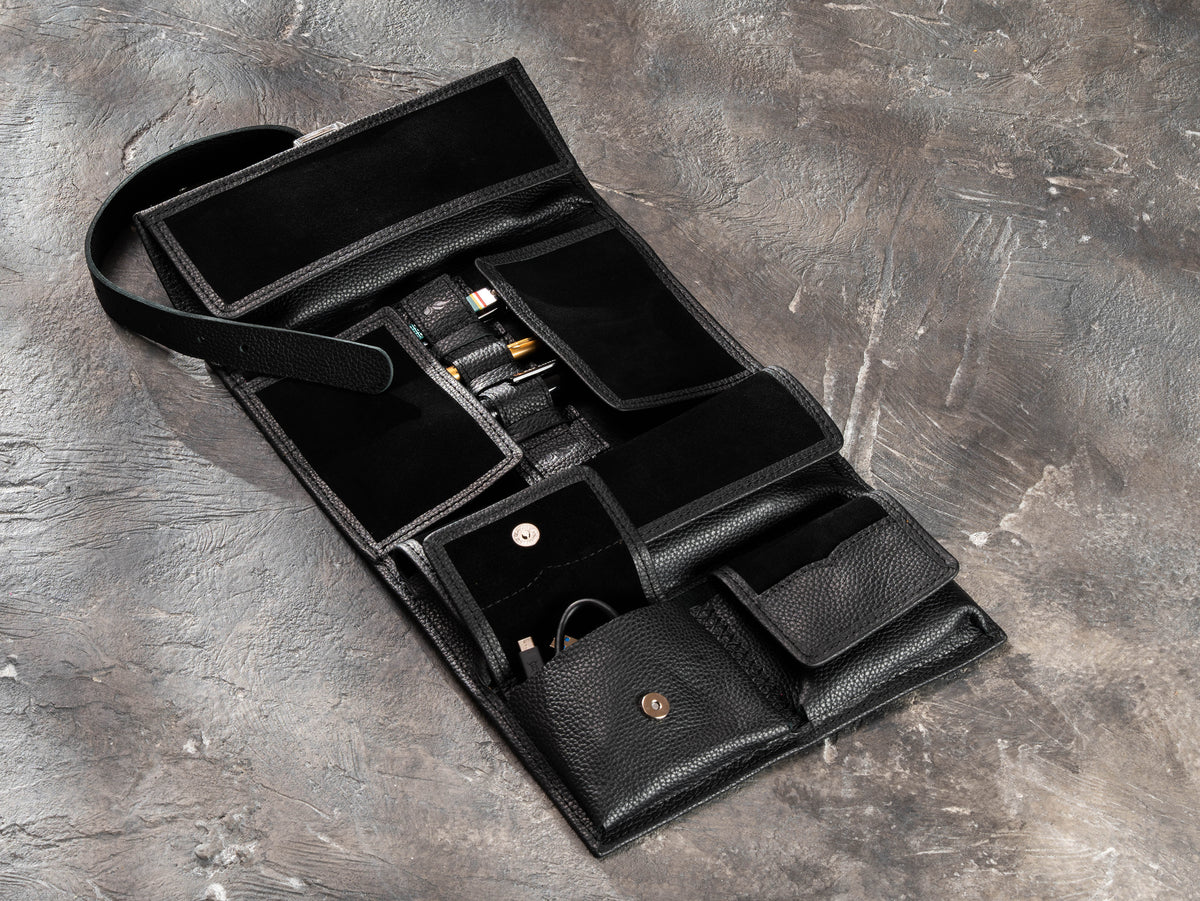 Open black leather travel organizer for men with magnetic pockets for cables, grooming tools and essentials