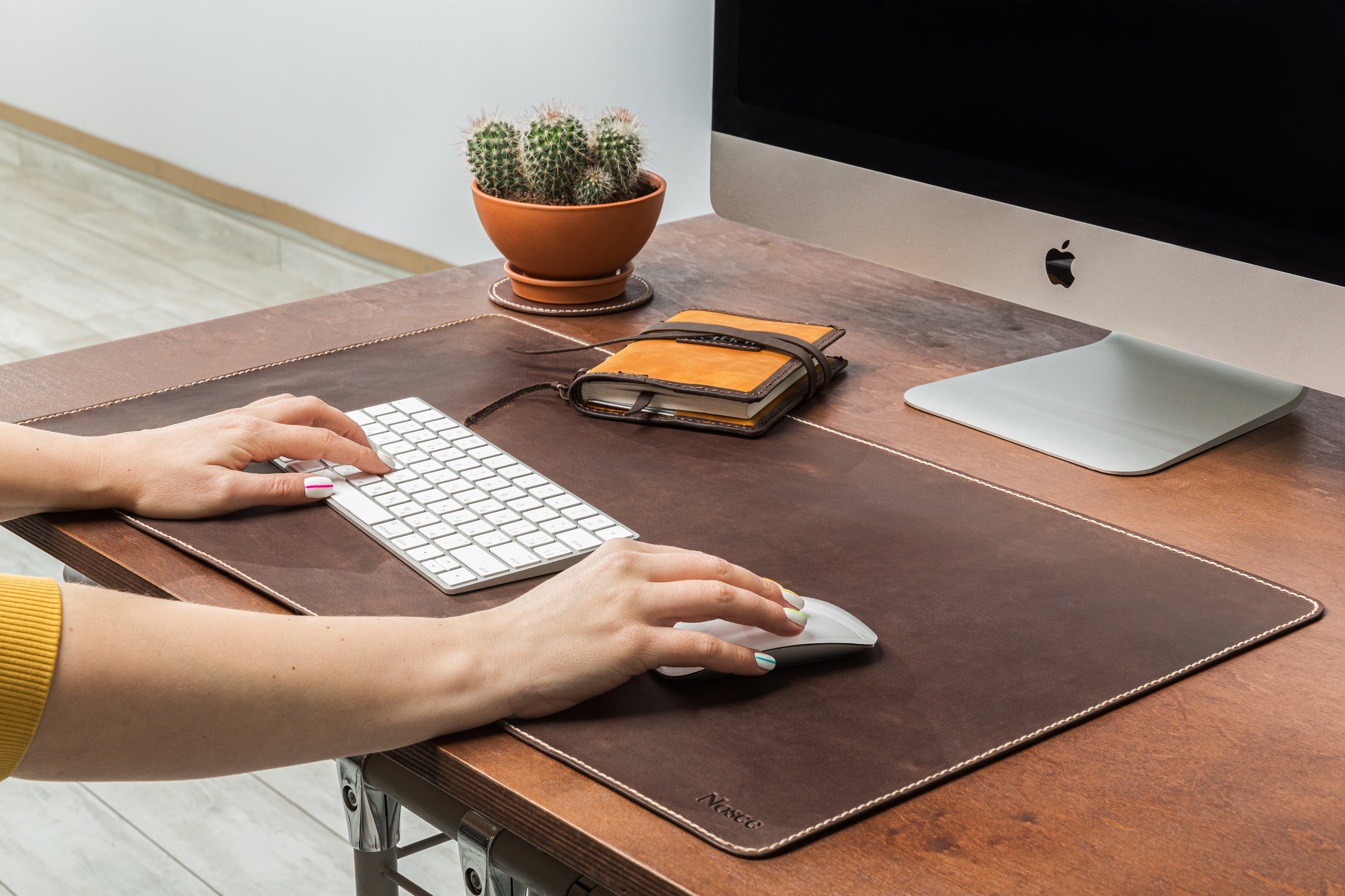 Brown vintage leather desk mat with beige stitching on desk – Mureli