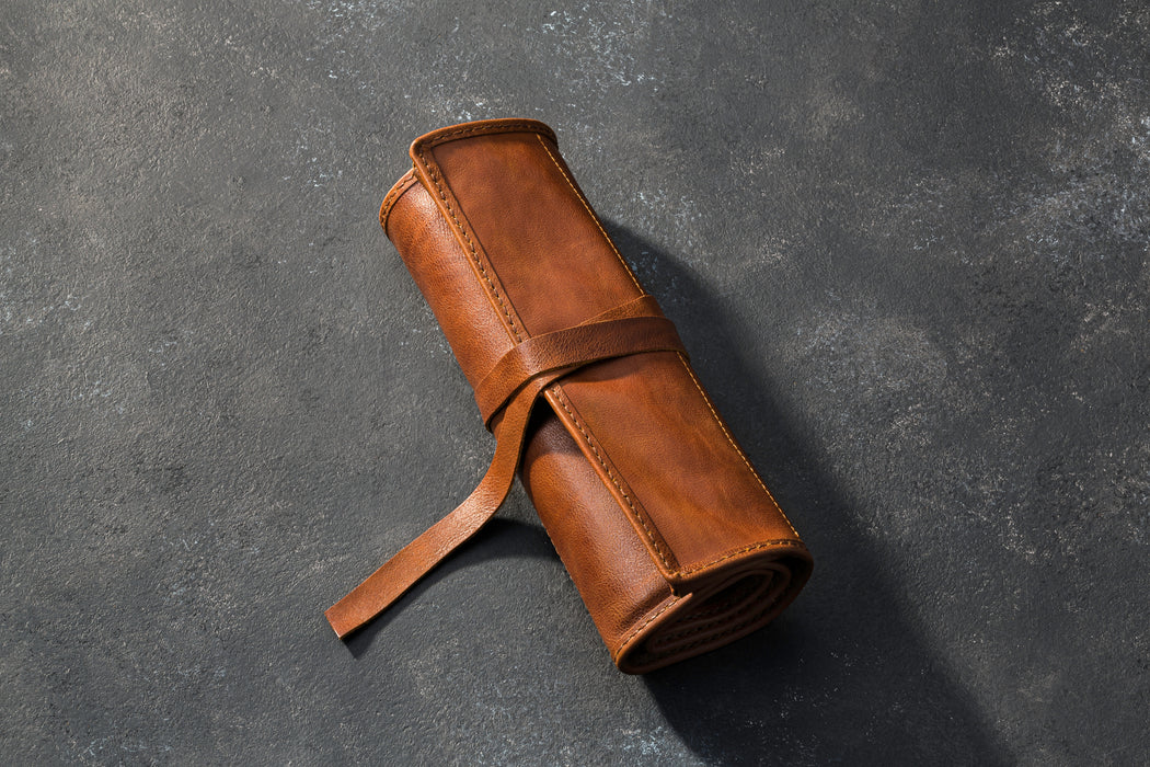 Brown leather roll on a dark gray background