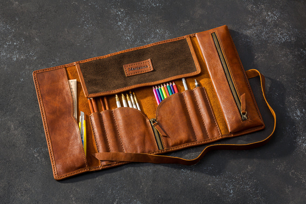 Brown leather pencil case with colorful pencils on a dark gray background standard size