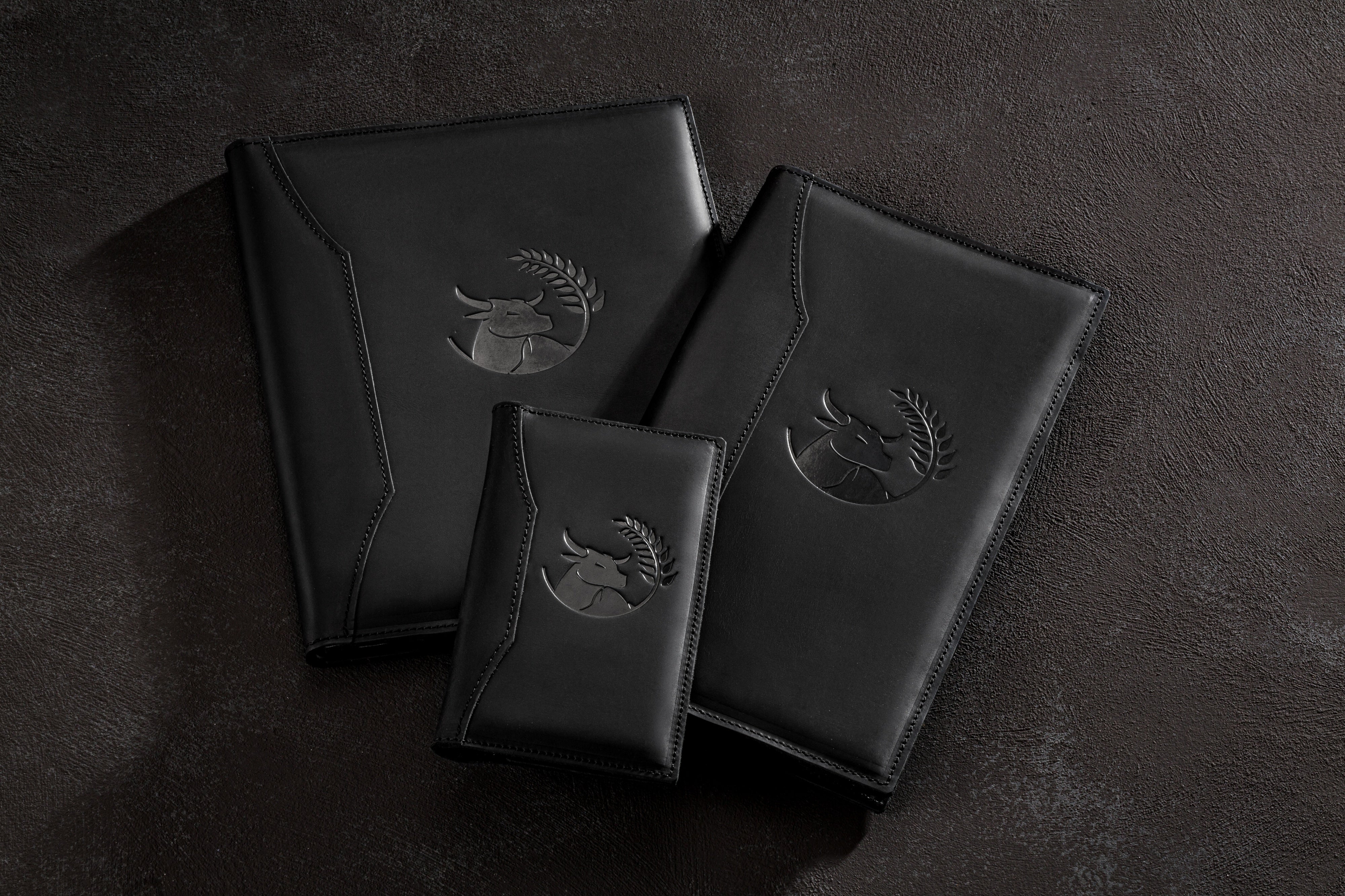 Open leather menu cover with printed pages and 3-ring binder mechanism