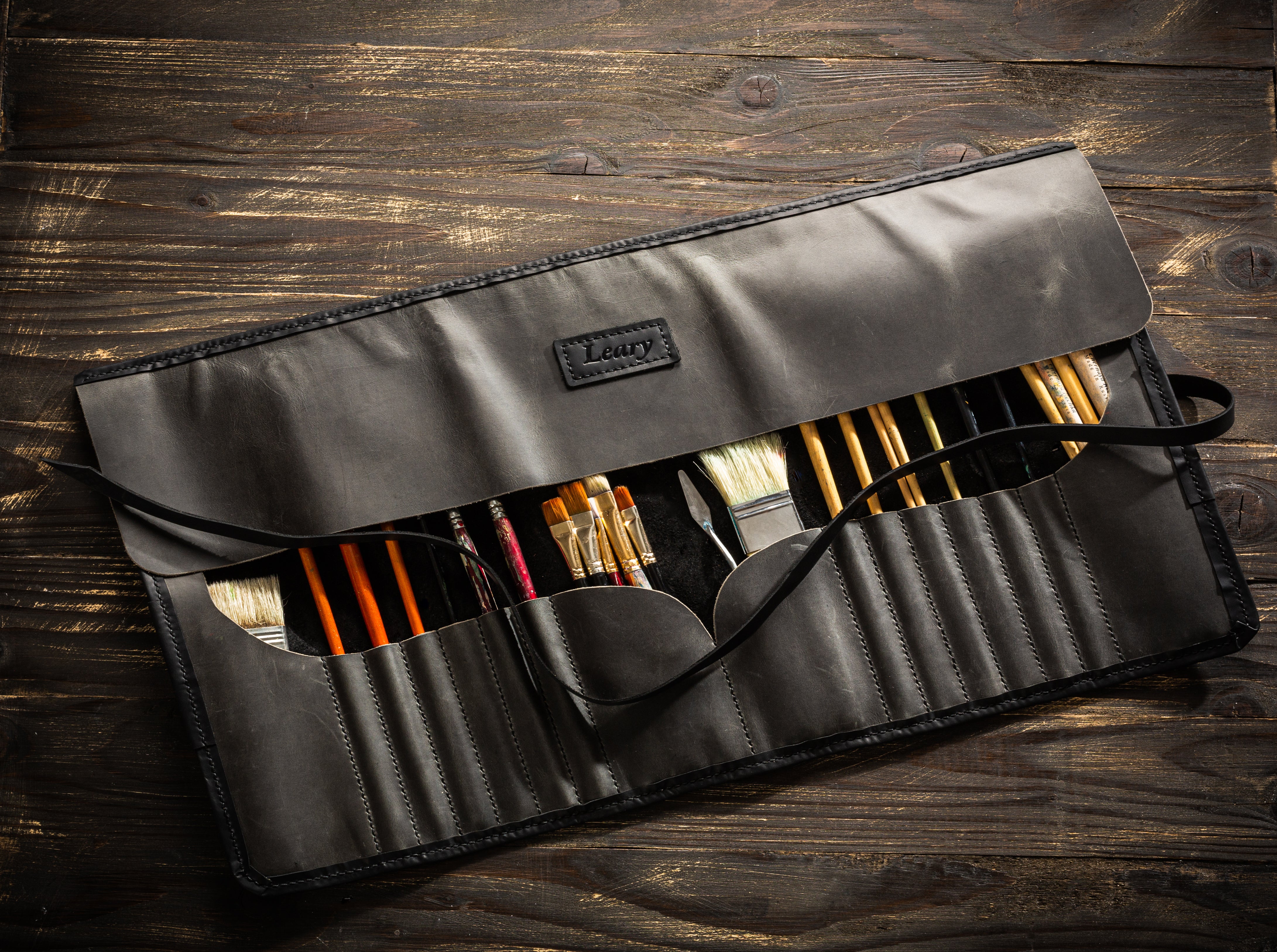 Charcoal black leather brush roll with personalized name tag for artists