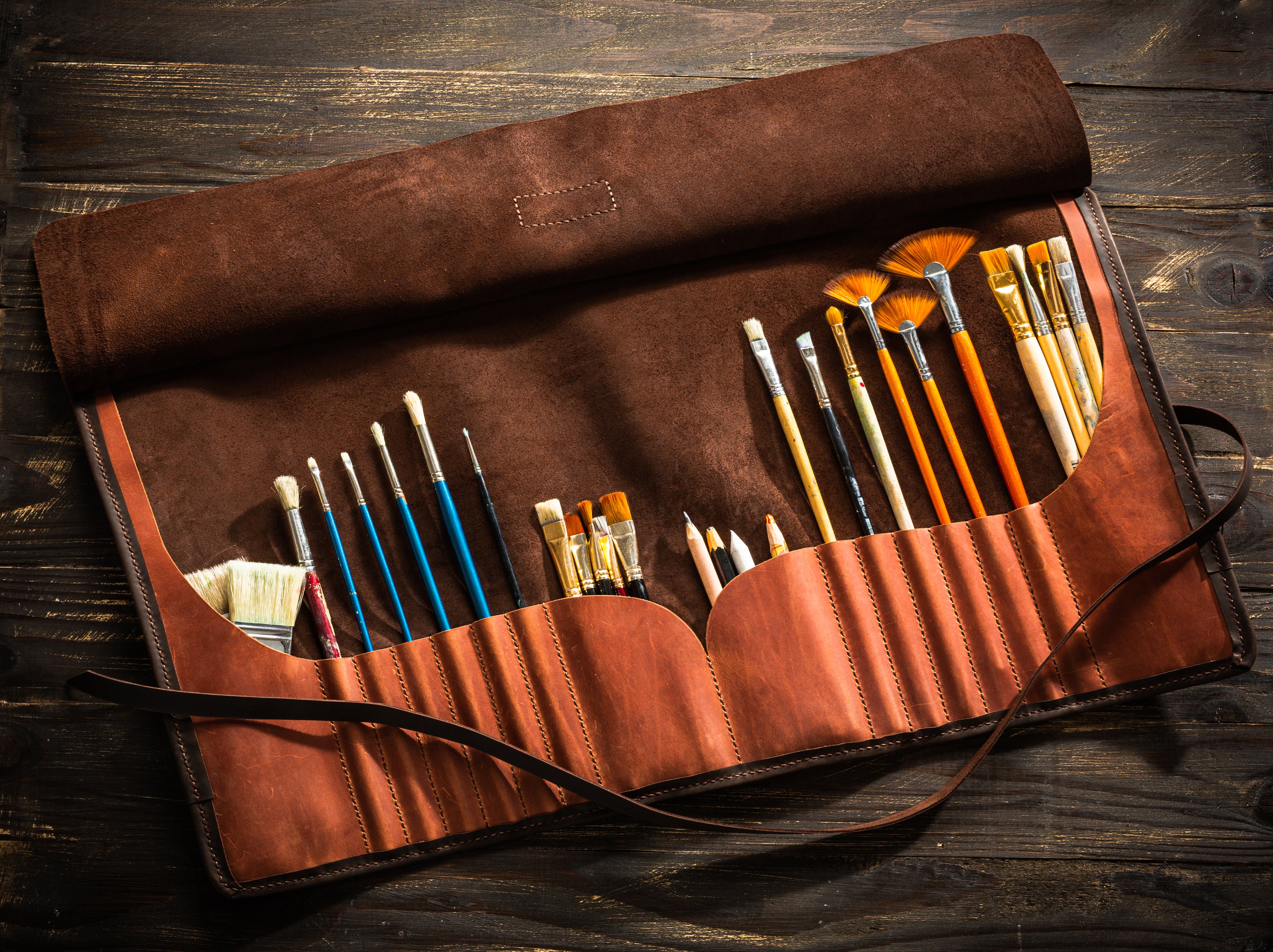 Open personalized leather brush roll for artists in Burnt Umber, handcrafted with suede interior