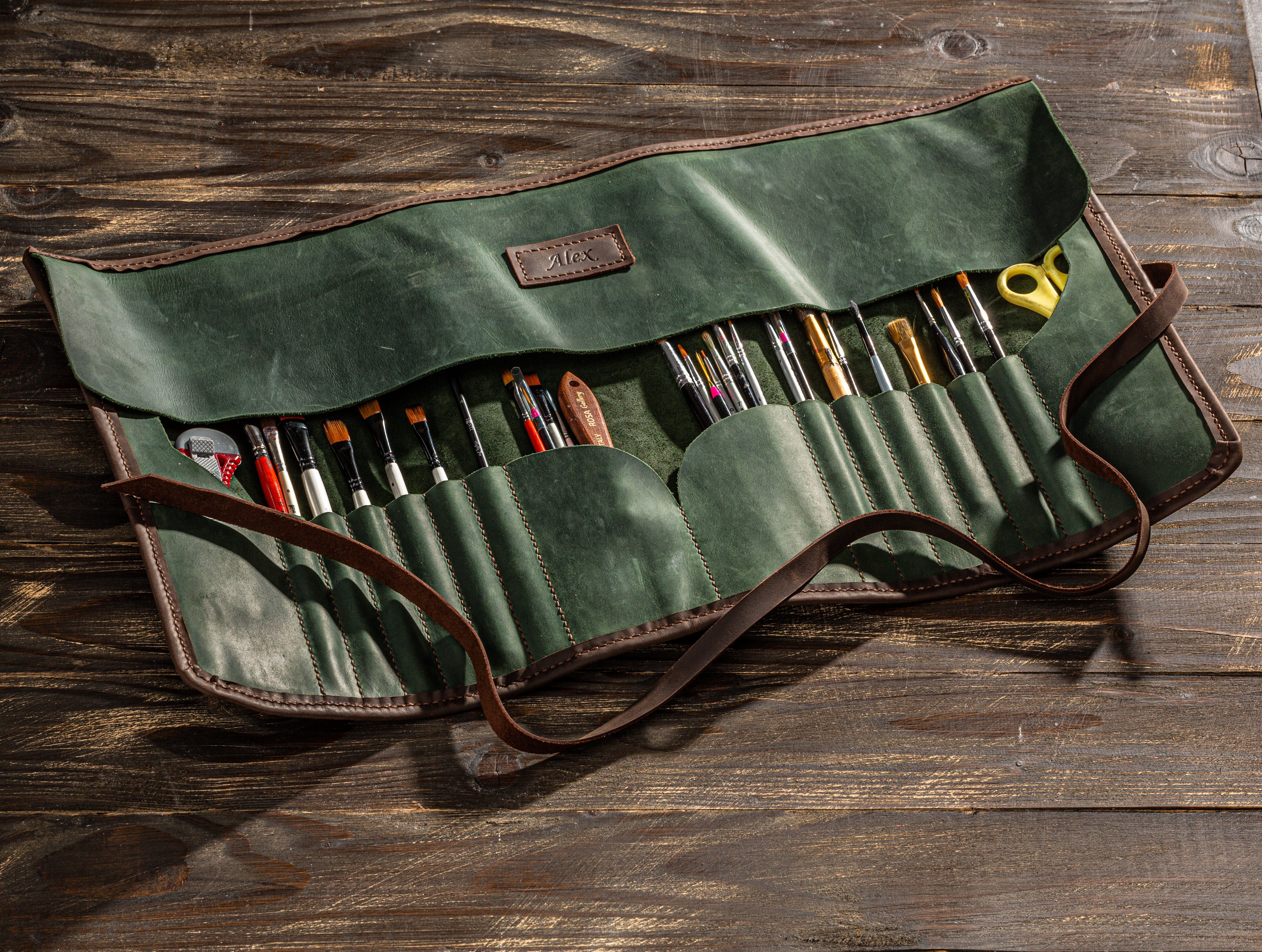 Leather roll-up case for artist tools in rich green color with brown trim