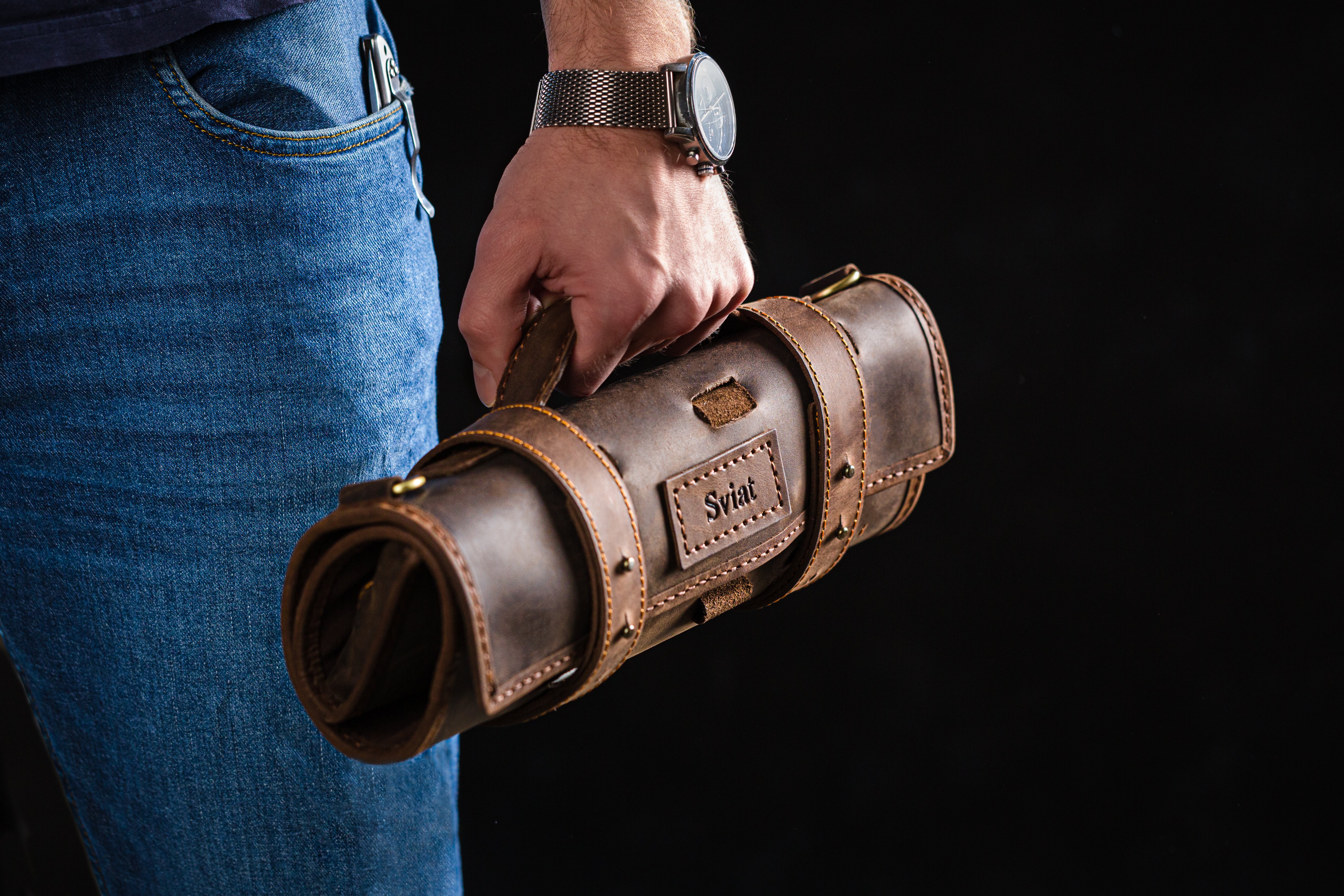 Rolled-up leather organizer with sturdy handle