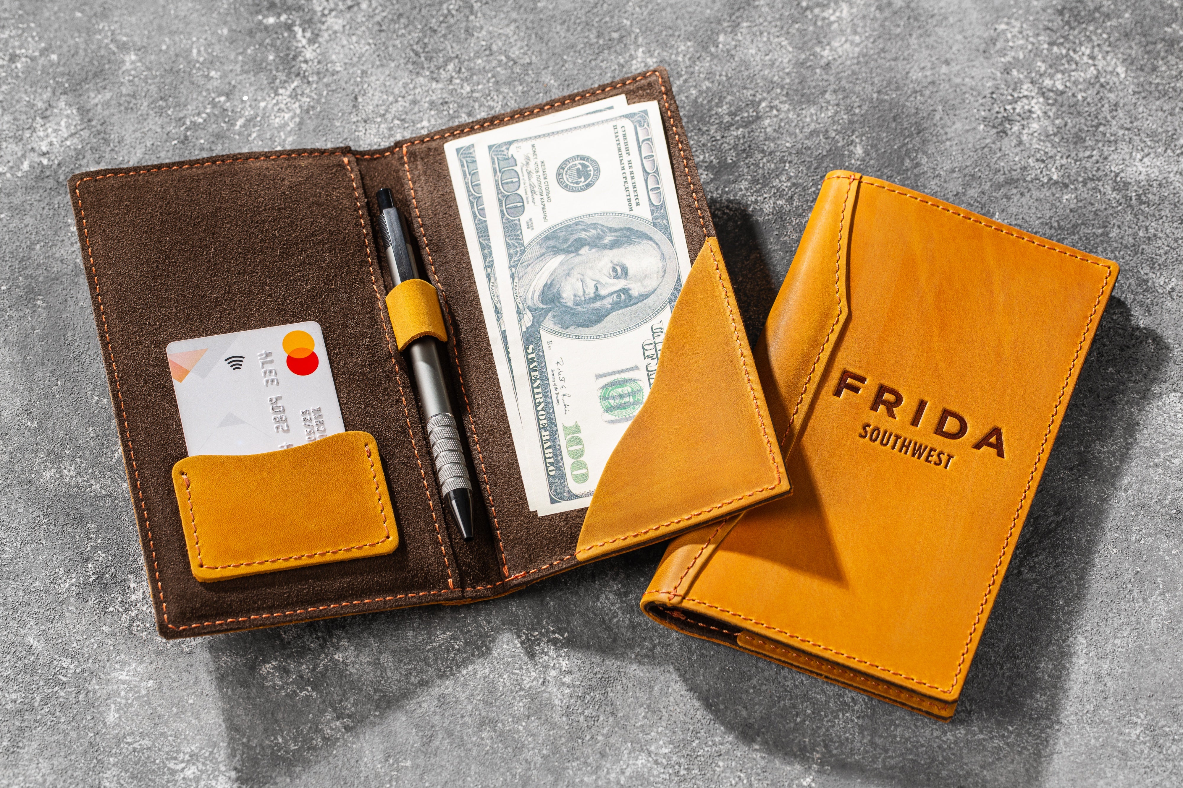 Yellow leather wallet-style check presenter closed
