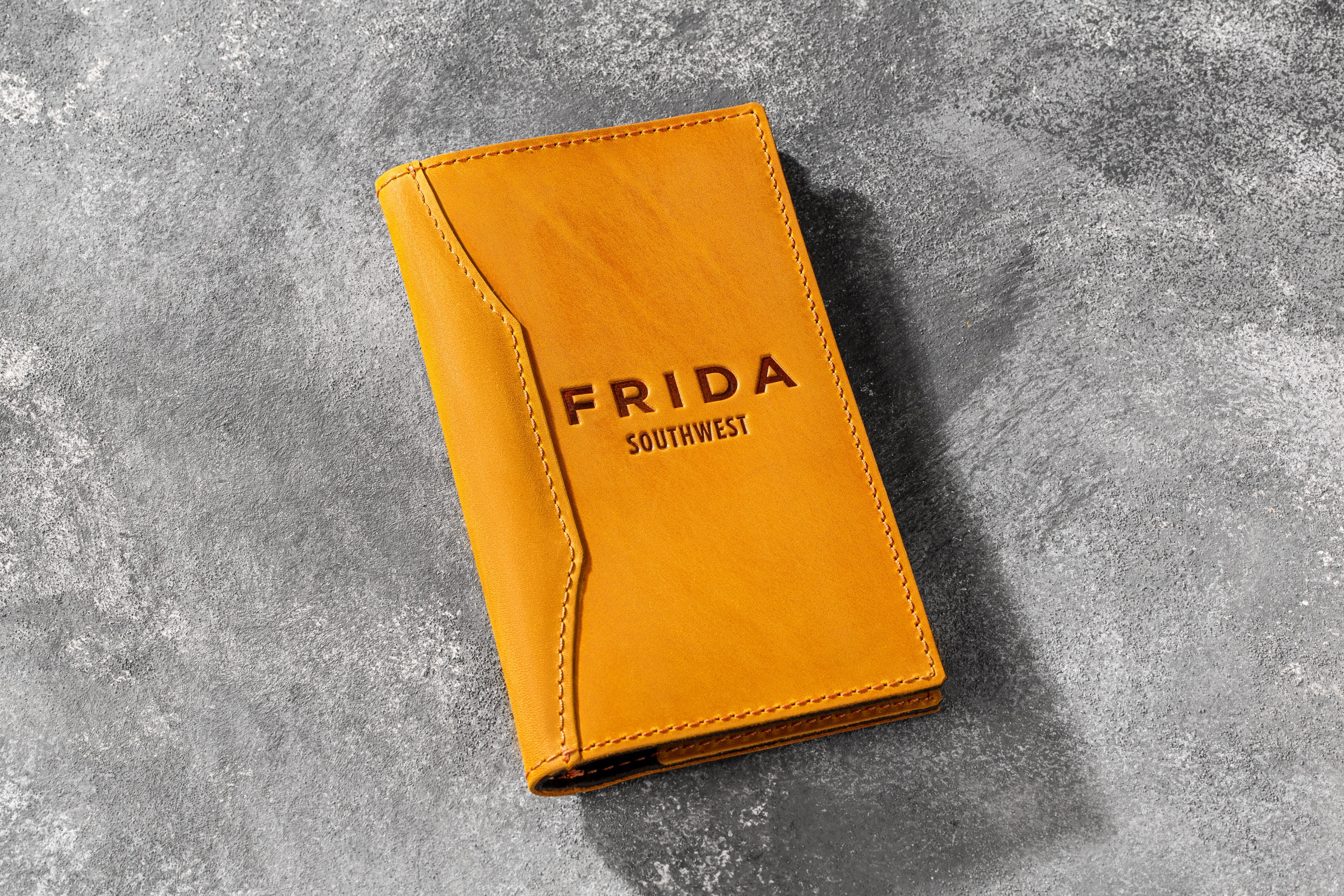 Leather check presenter with pen, cash, and card inside