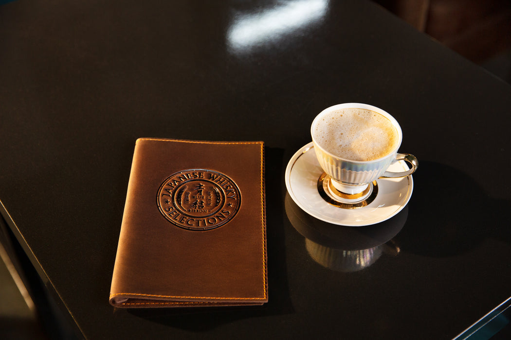 Leather menu cover showing stitched edge and folded A5 insert