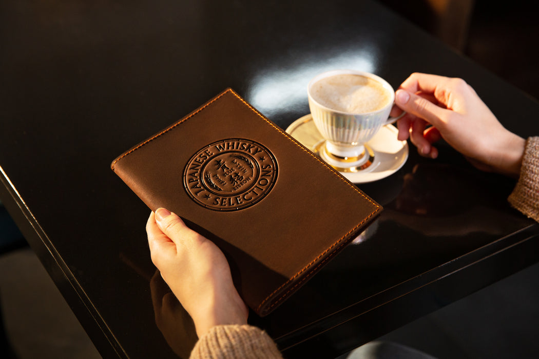 Café setting with leather menu folder and printed folded sheets
