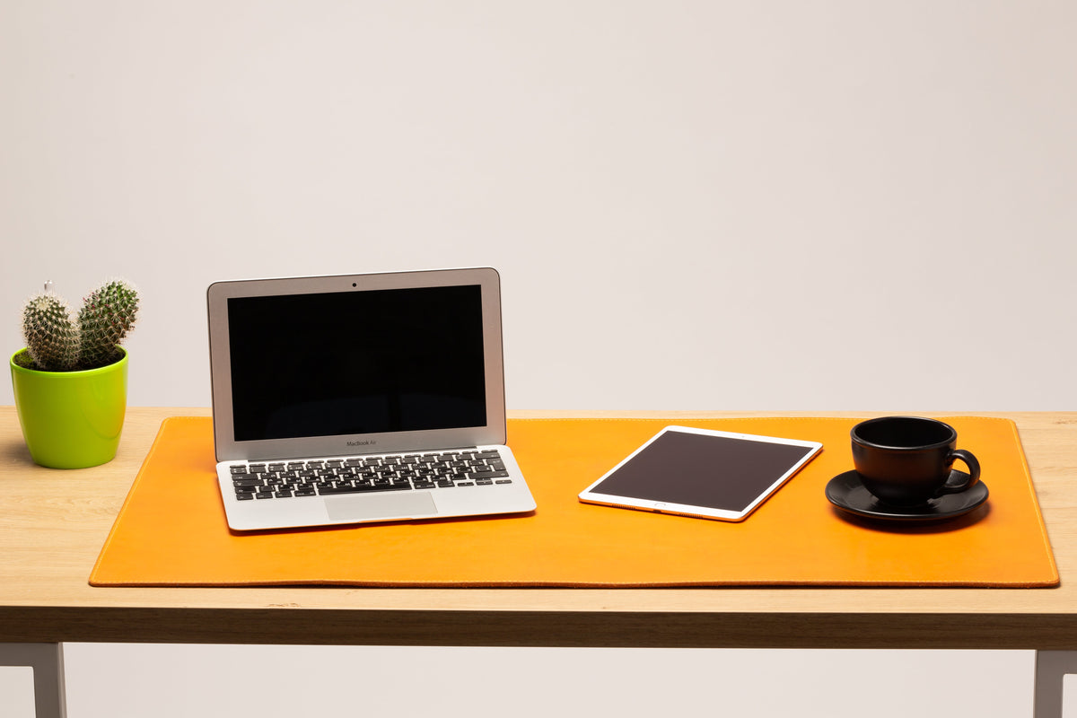Large Golden Wheat leather desk mat on wooden office desk with laptop, tablet and coffee cup