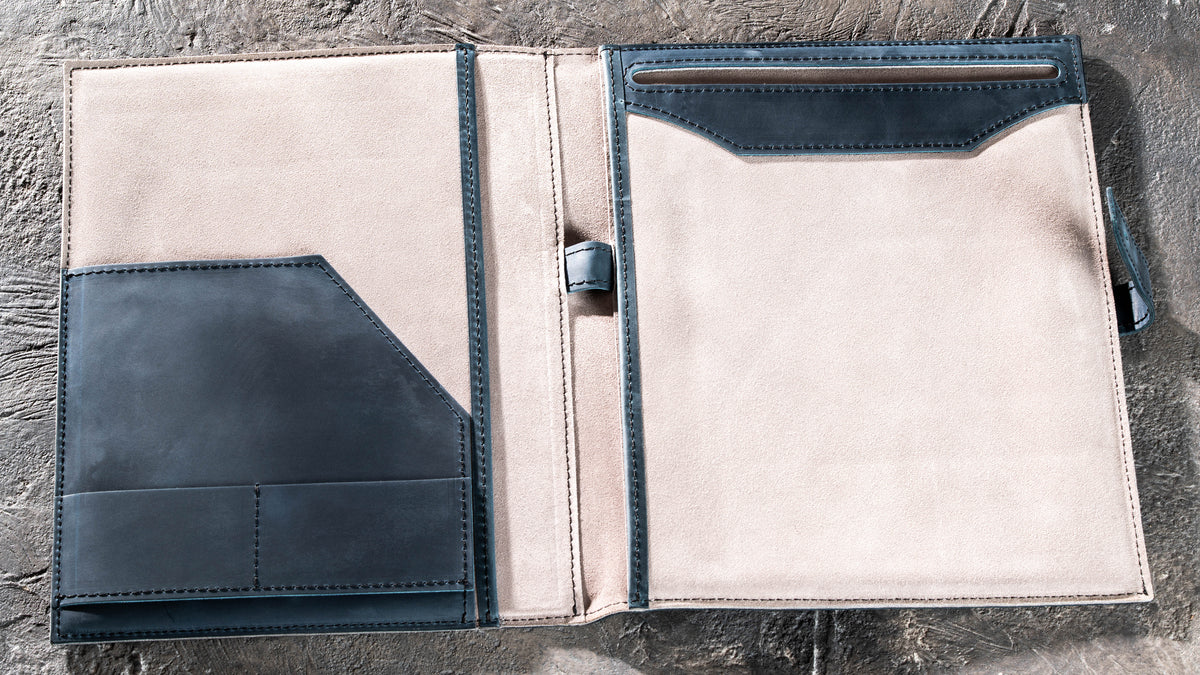 Open Navy Blue leather padfolio with suede interior, document pockets, card slots and pen loop