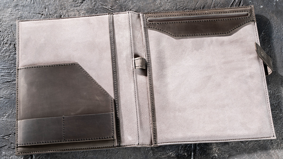 Open Gray leather padfolio with suede interior, document pockets, card slots and pen loop