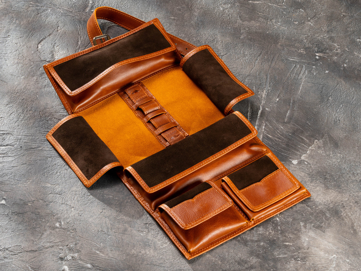 Empty camel hanging roll-up leather travel organizer showing interior layout, pockets and holders