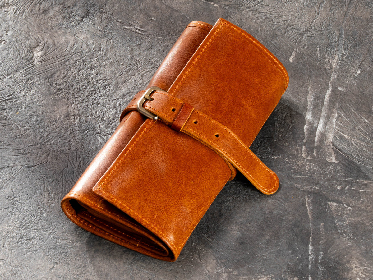 Closed camel hanging roll-up leather travel organizer with buckle strap
