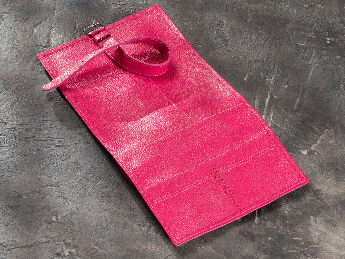Raspberry Pink leather travel organizer opened flat showing exterior, buckle strap and reinforced hand stitching