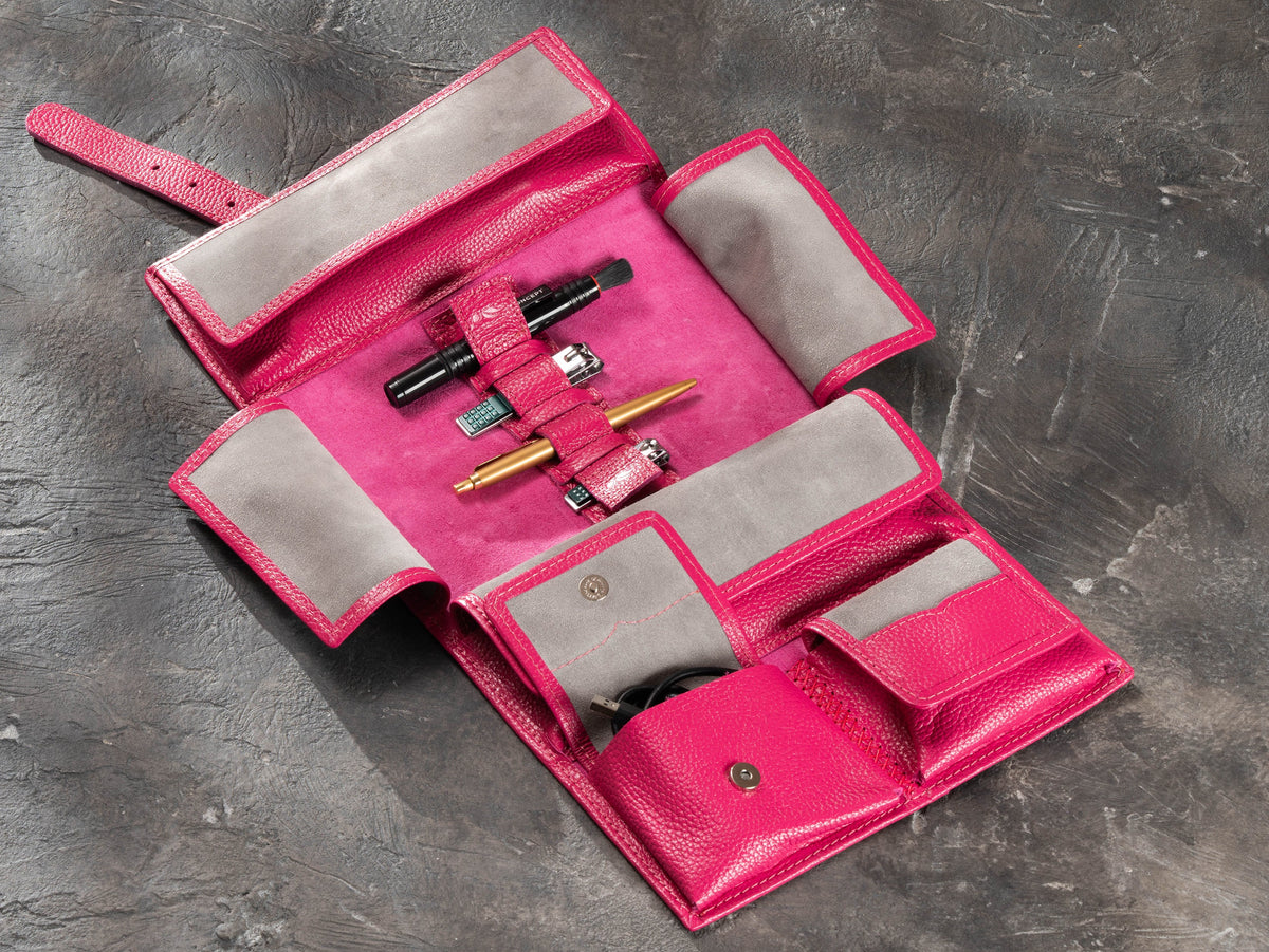 Raspberry Pink roll-up leather travel organizer fully opened with elastic holders, magnetic pockets and travel essentials
