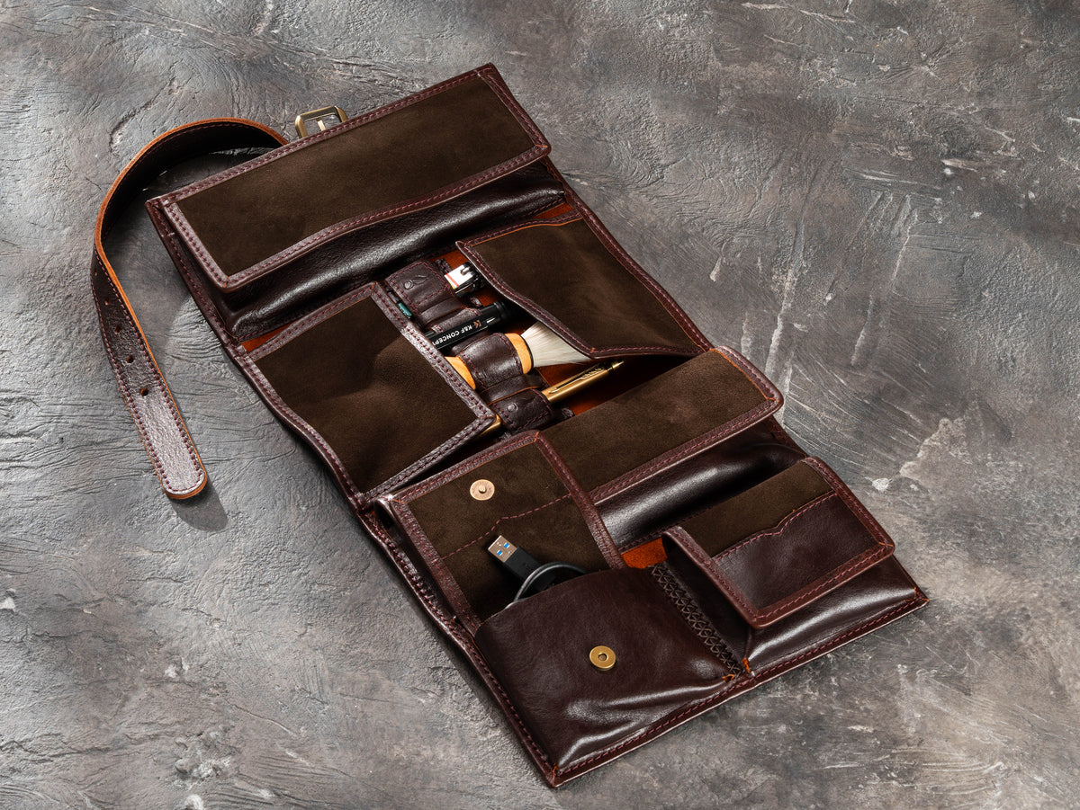 Dark Brown leather travel organizer opened flat showing exterior, buckle strap and reinforced hand stitching