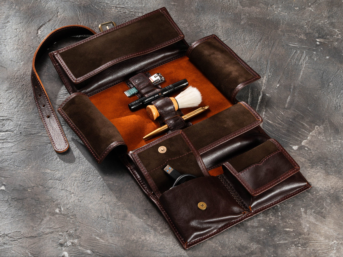 Open Dark Brown hanging leather travel organizer with magnetic pockets, grooming tools and cable storage