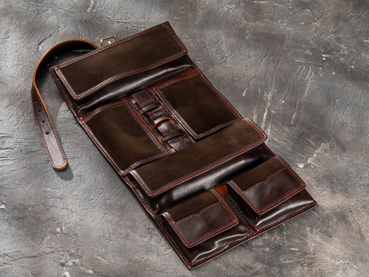 Dark Brown roll-up leather travel organizer fully opened with suede interior, elastic holders and travel accessories