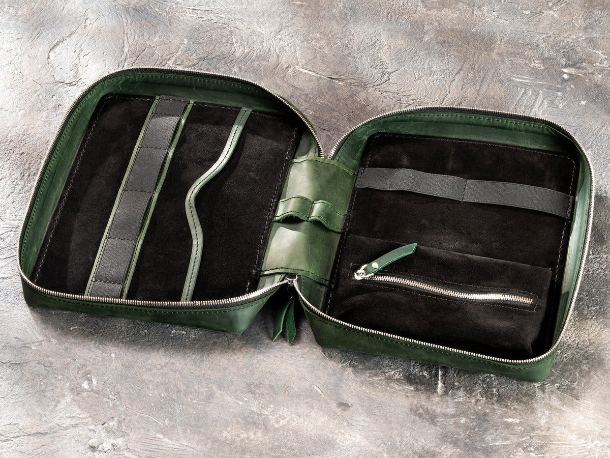 Open Forest Green zippered travel organizer showing flat pocket, elastic holders, suede interior and inner zip pouch