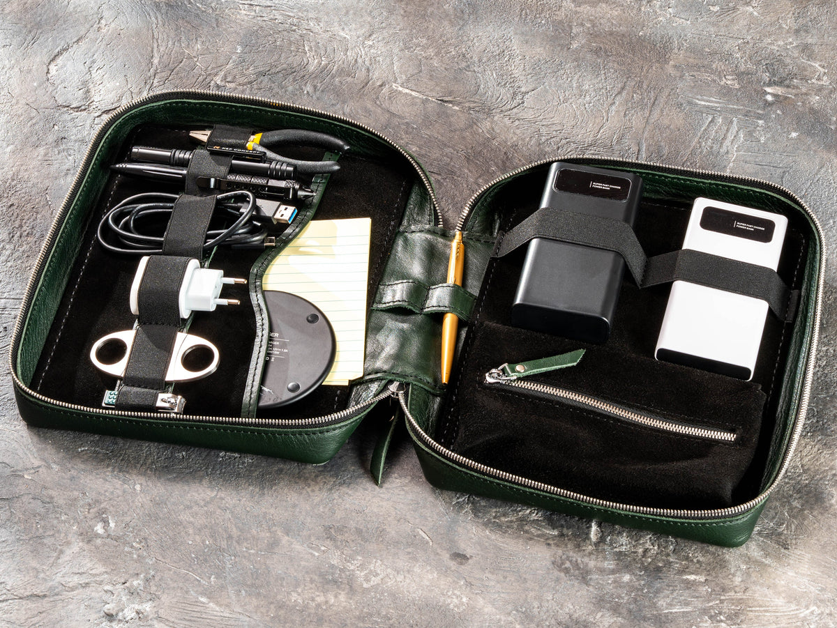 Open Dark Green leather travel organizer case with chargers, cables, power banks and everyday essentials